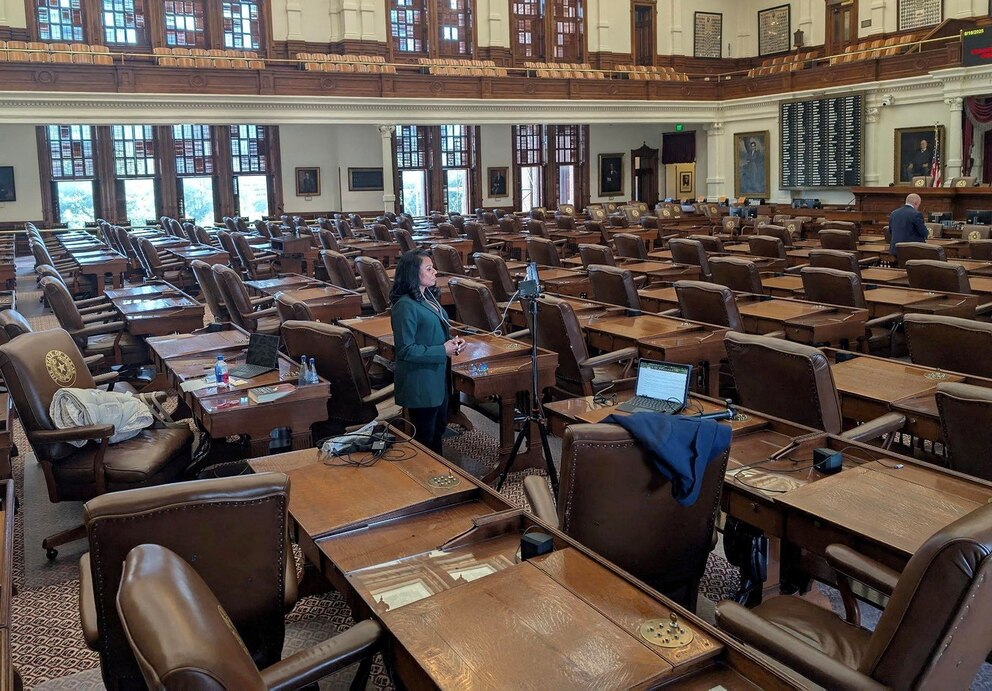 PHOTO: State Rep. Nicole Collier talks on the phone from the floor of the House after Democratic lawmakers who had left the state to prevent Republicans from redrawing Texas's 38 congressional districts returned to the Capitol in Austin, Aug. 18, 2025.