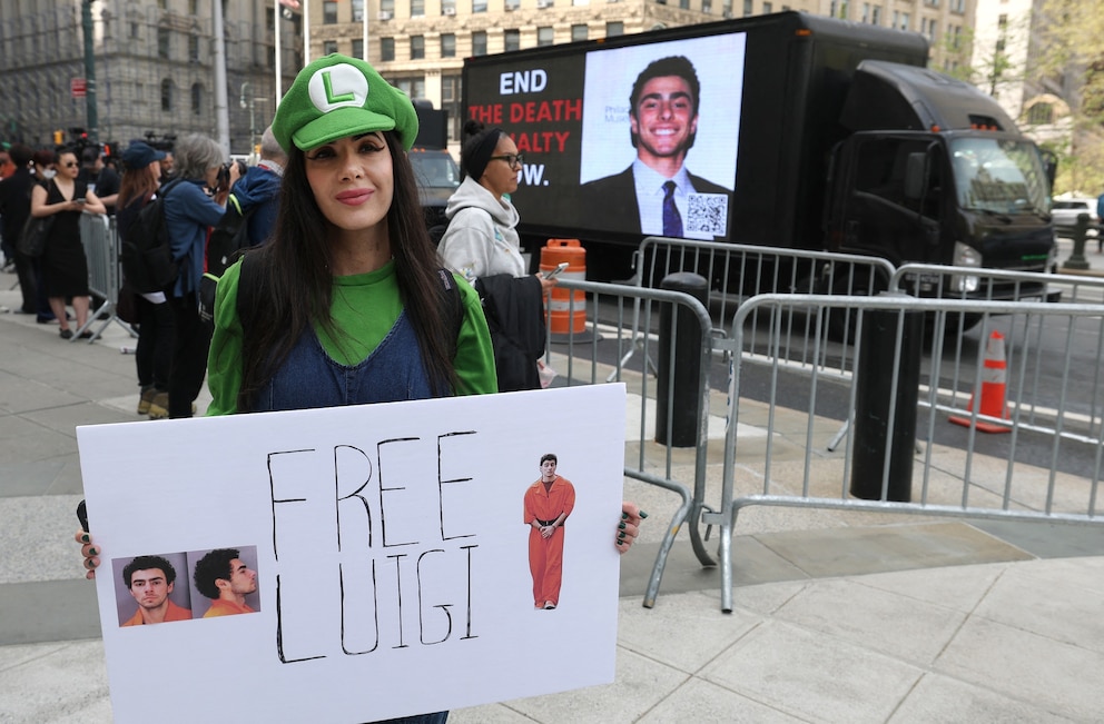 PHOTO: A protestor outside Manhattan Federal Court, April 25, 2025, to attend court as Luigi Mangione is set to be arraigned in New York federal court  on a four-count indictment for the murder of United Healthcare CEO Brian Thompson. 