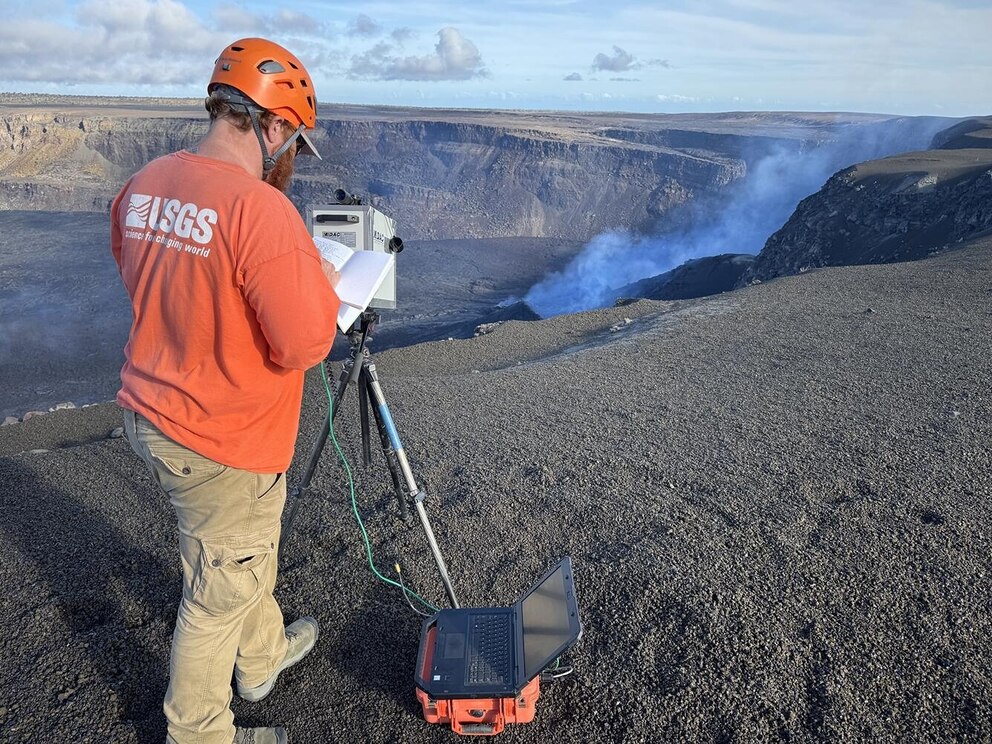 PHOTO: A USGS Hawaiian Volcano Observatory geologist measures the chemical composition of volcanic gas during cycles of spattering and seismic tremor at the active vent at Kīlauea summit on May 22, 2025. 