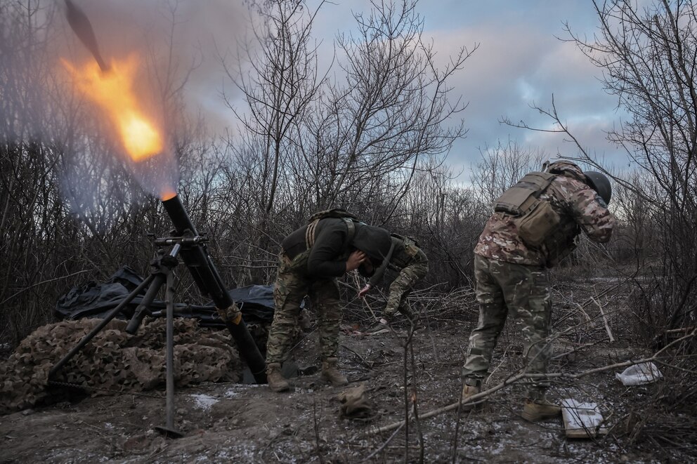 PHOTO: TOPSHOT - This handout photograph taken by the Press service of the 24th Mechanized Brigade of Ukrainian Armed Forces on Feb. 8, 2025 shows Ukrainian servicemen of the 24th Mechanized Brigade firing a 120mm mortar towards Russian positions.