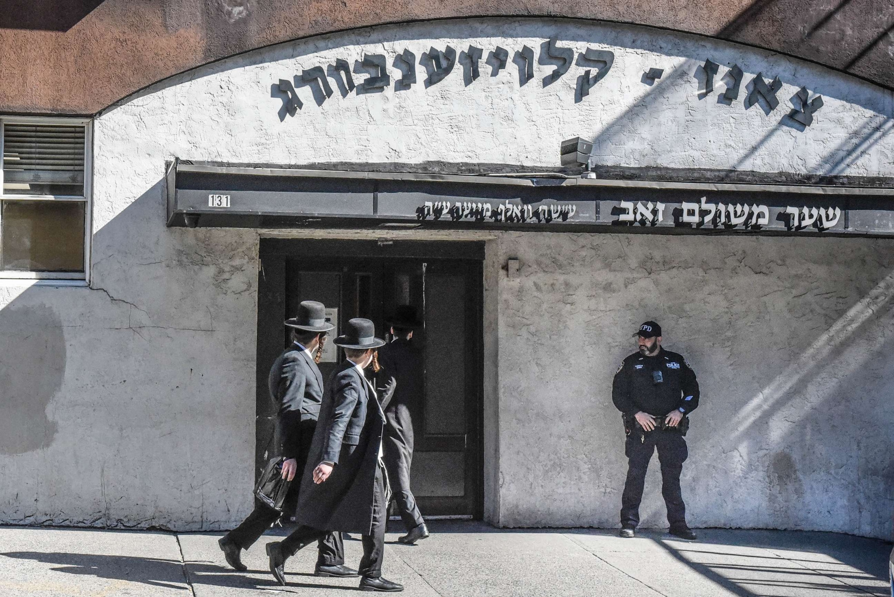 PHOTO: A member of the New York Police Department patrols in front of a synagogue on Oct. 13, 2023 in the Williamsburg neighborhood in the borough of Brooklyn in New York City.