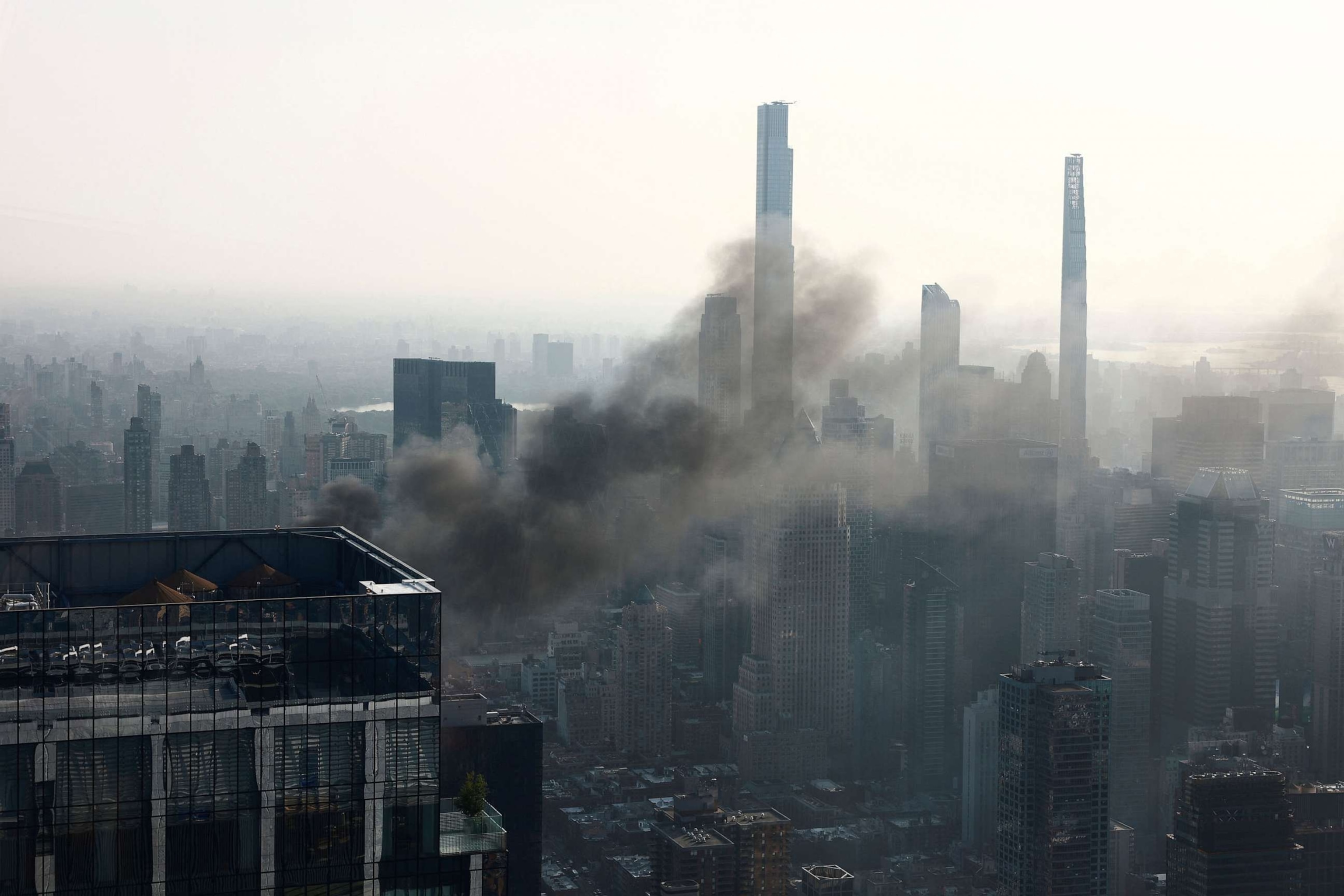 PHOTO: Smoke is visible after a construction crane caught fire on a high-rise building in Manhattan, New York City, July 26, 2023.