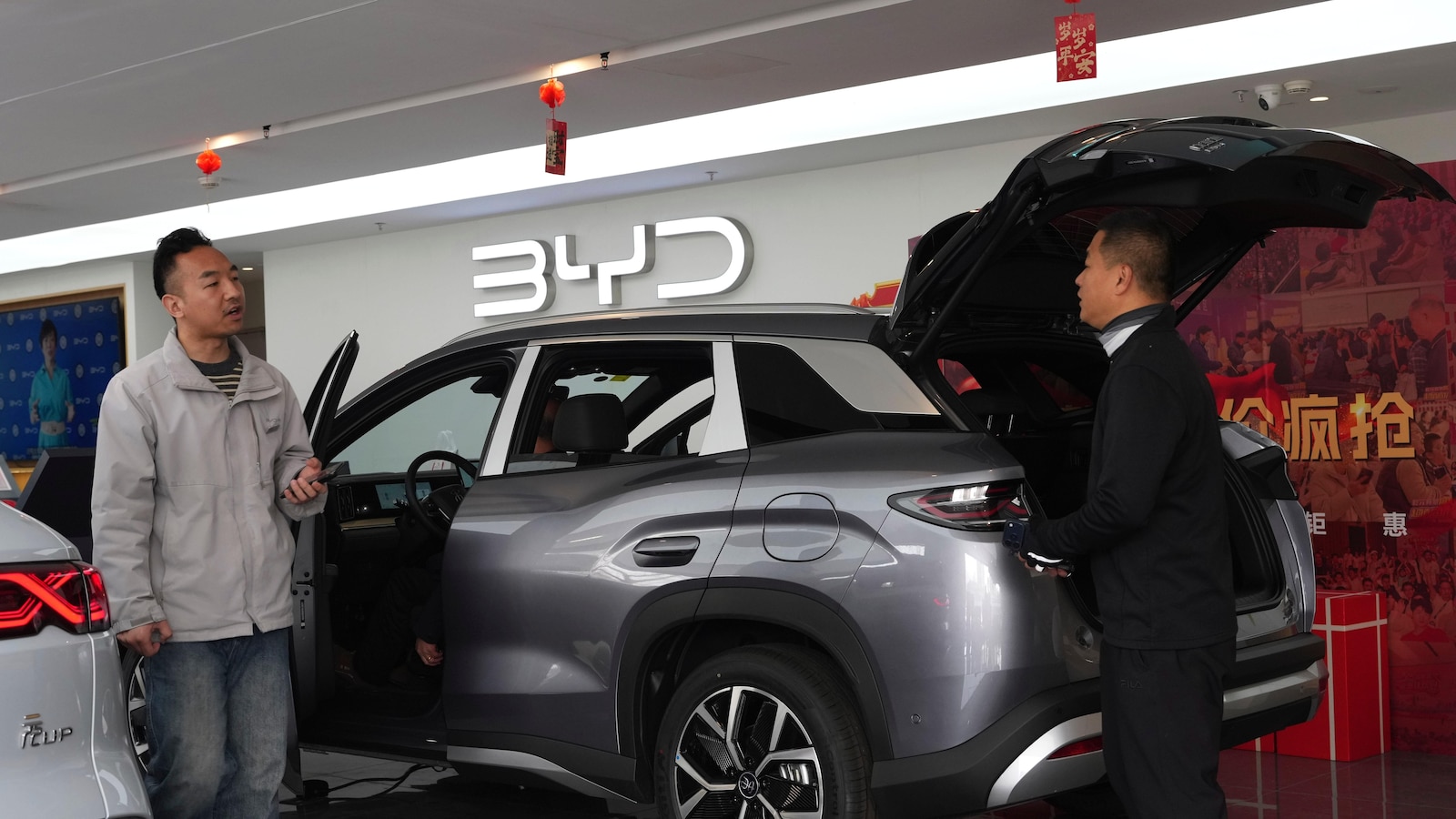 China's BYD sees 1st profit drop since 2021, but Tesla-rival takes global EV crown