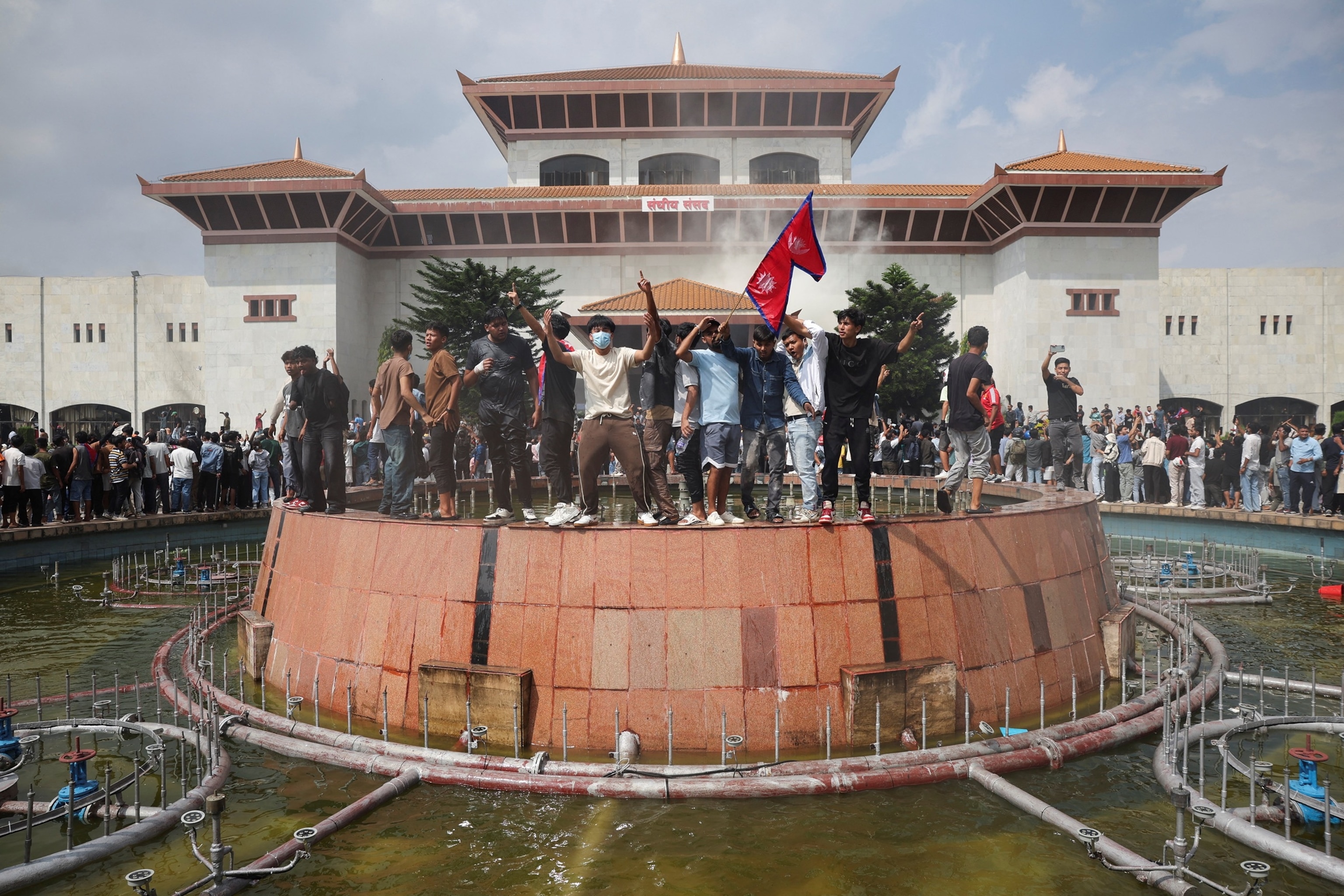 PHOTO: Demonstrators celebrate after entering the Parliament complex during a protest against Monday's killing of 19 people after anti-corruption protests that were triggered by a social media ban, in Kathmandu, Nepal, Sept. 9, 2025.
