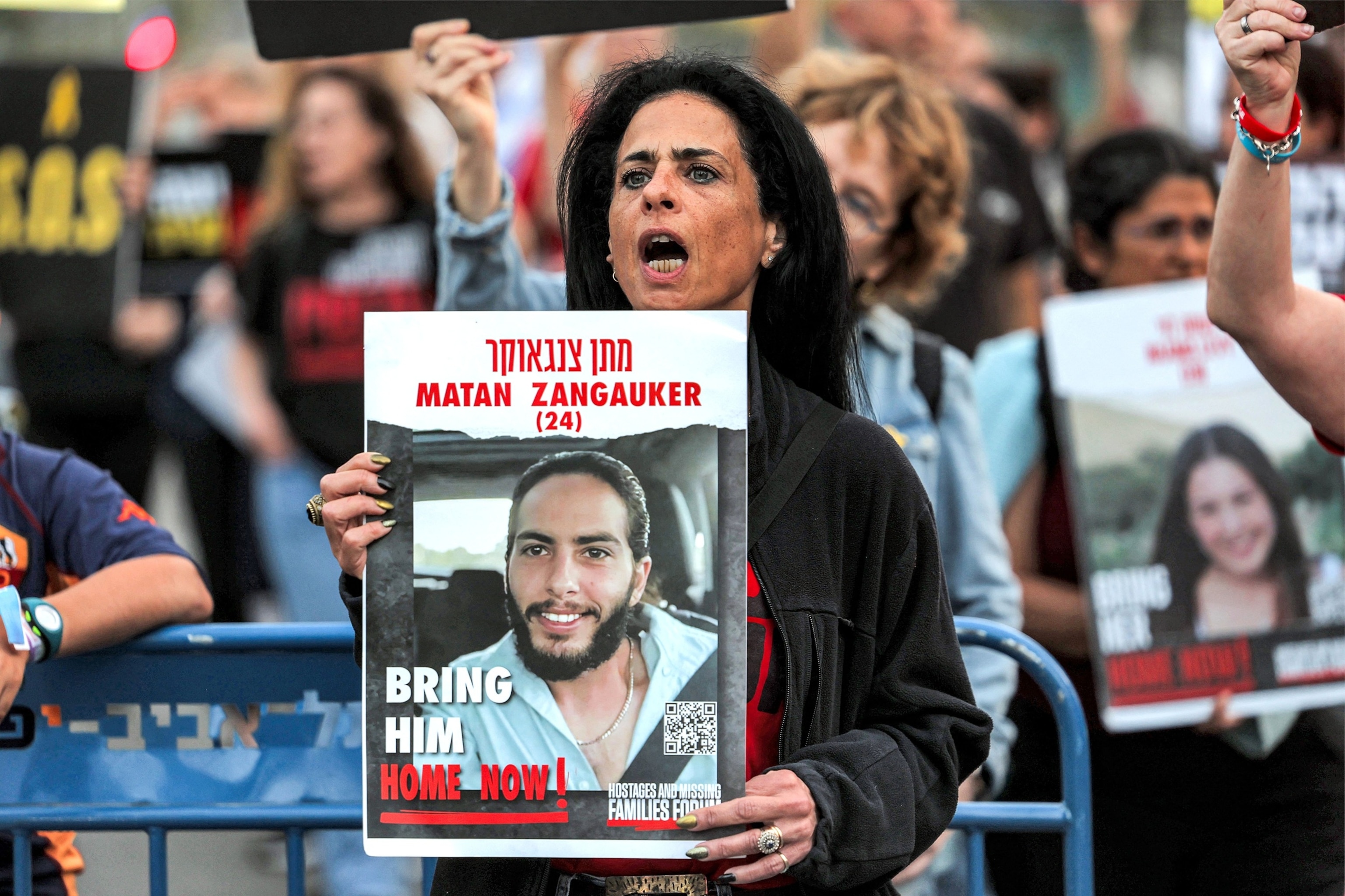 PHOTO: In this April 18, 2024, file photo, a woman holds a sign identifying Matan Zangauker (24) during a demonstration in Tel Aviv.