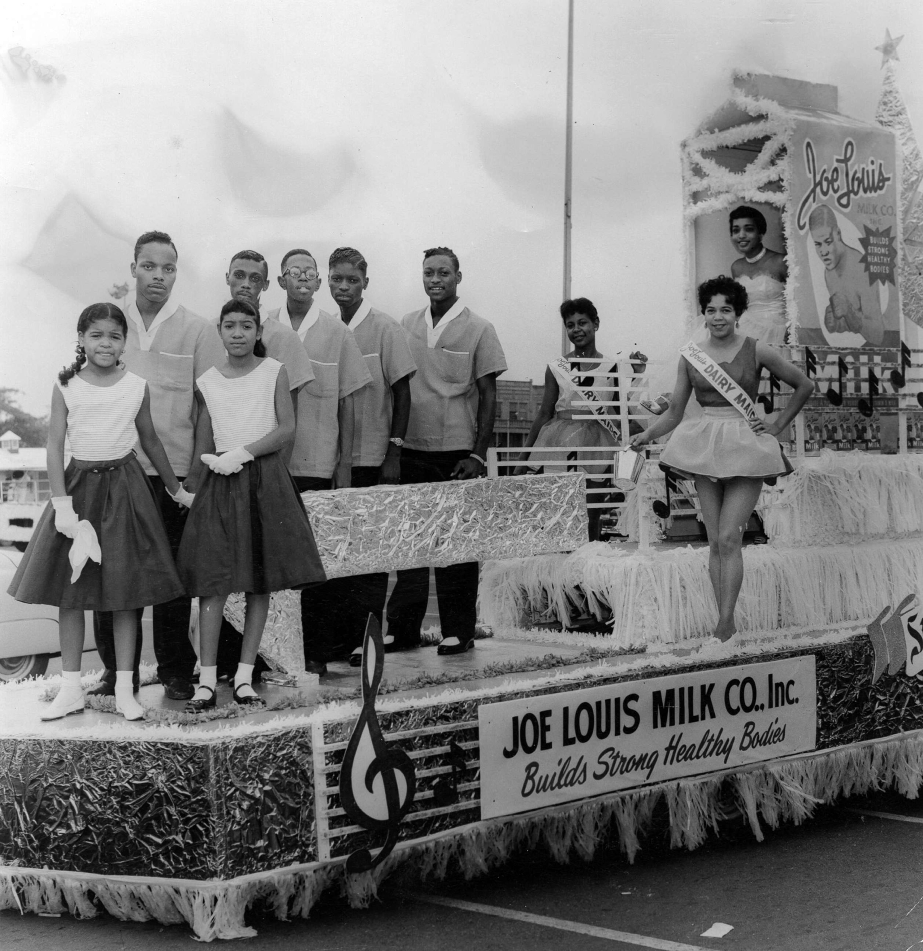 PHOTO: Representatives of the Joe Louis Milk Company ride atop their float, during the annual Bud Billiken Day parade, in Chicago, in 1958. 