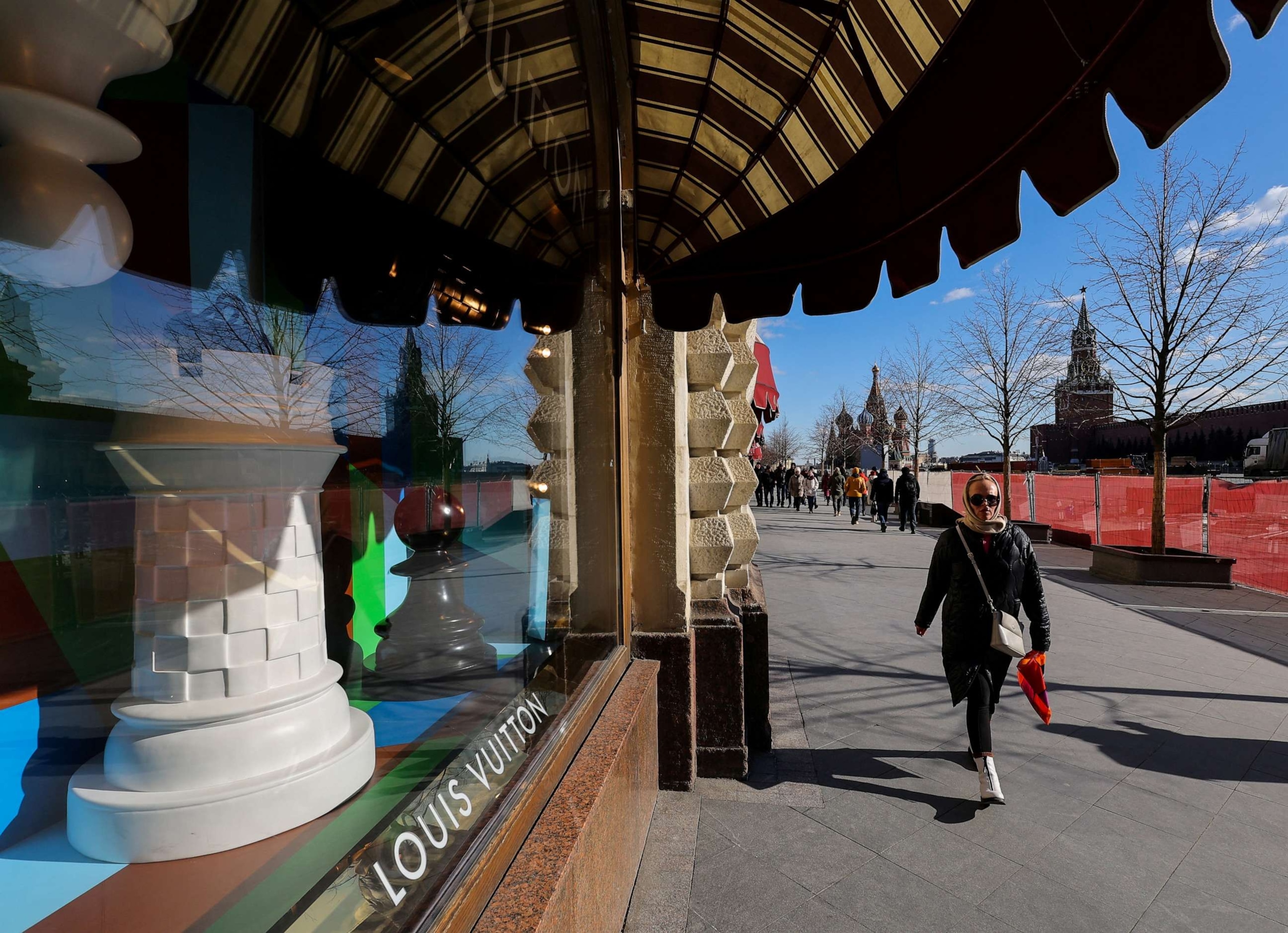 FILE PHOTO: A woman walks past a closed Louis Vuitton boutique in the GUM department store in Red square in Moscow, Russia, on March 15, 2022.