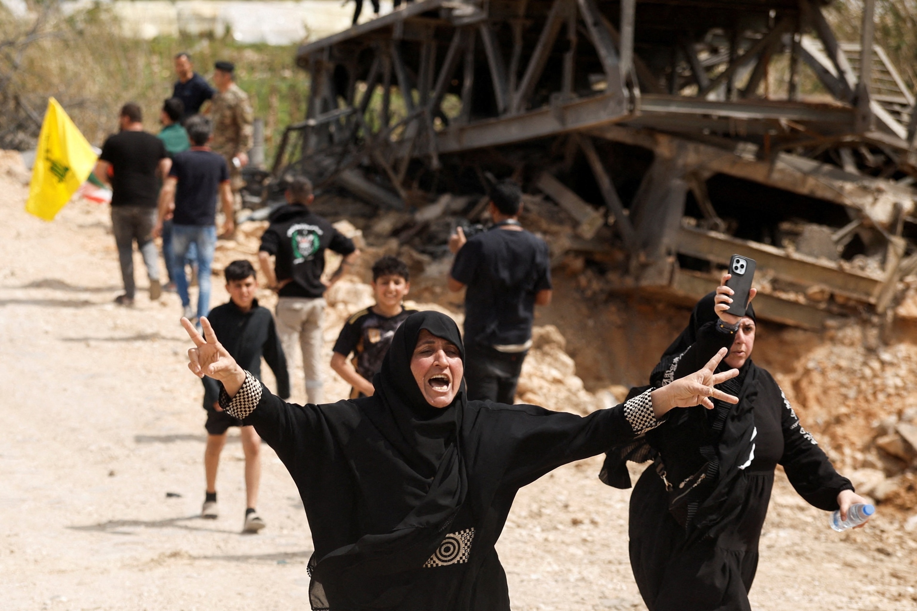 PHOTO: Women react as displaced people make their way back to their homes crossing the bridge linking southern Lebanon to the rest of the country after a 10-day ceasefire between Lebanon and Israel went into effect, in Qasmiyeh, Lebanon, April 17, 2026.