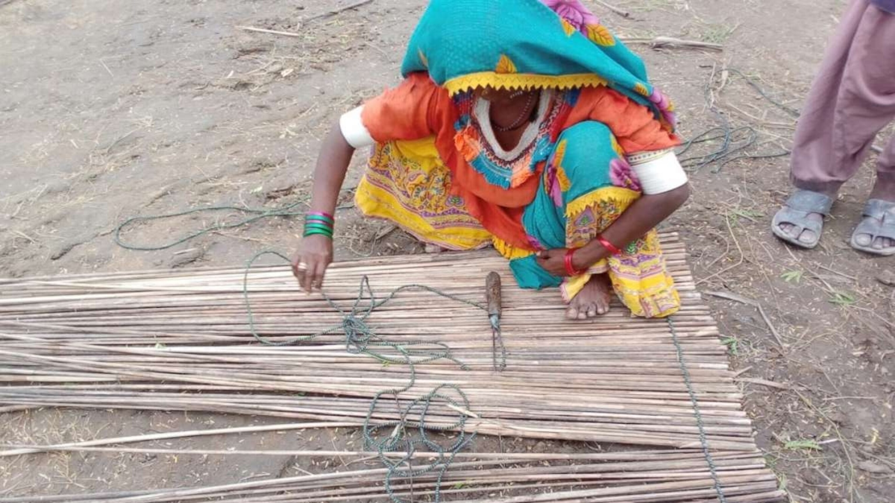 PHOTO: A community member crafts matting from shelter materials in the Karigar village near Pono Markaz, an area designed for rehabilitation and livelihood opportunities for flood-affected communities in the southeastern Pakistan, on July 16, 2022.