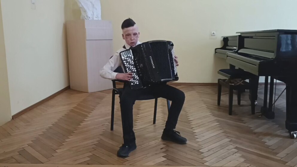 PHOTO: Roman Oleksiv playing accordion.