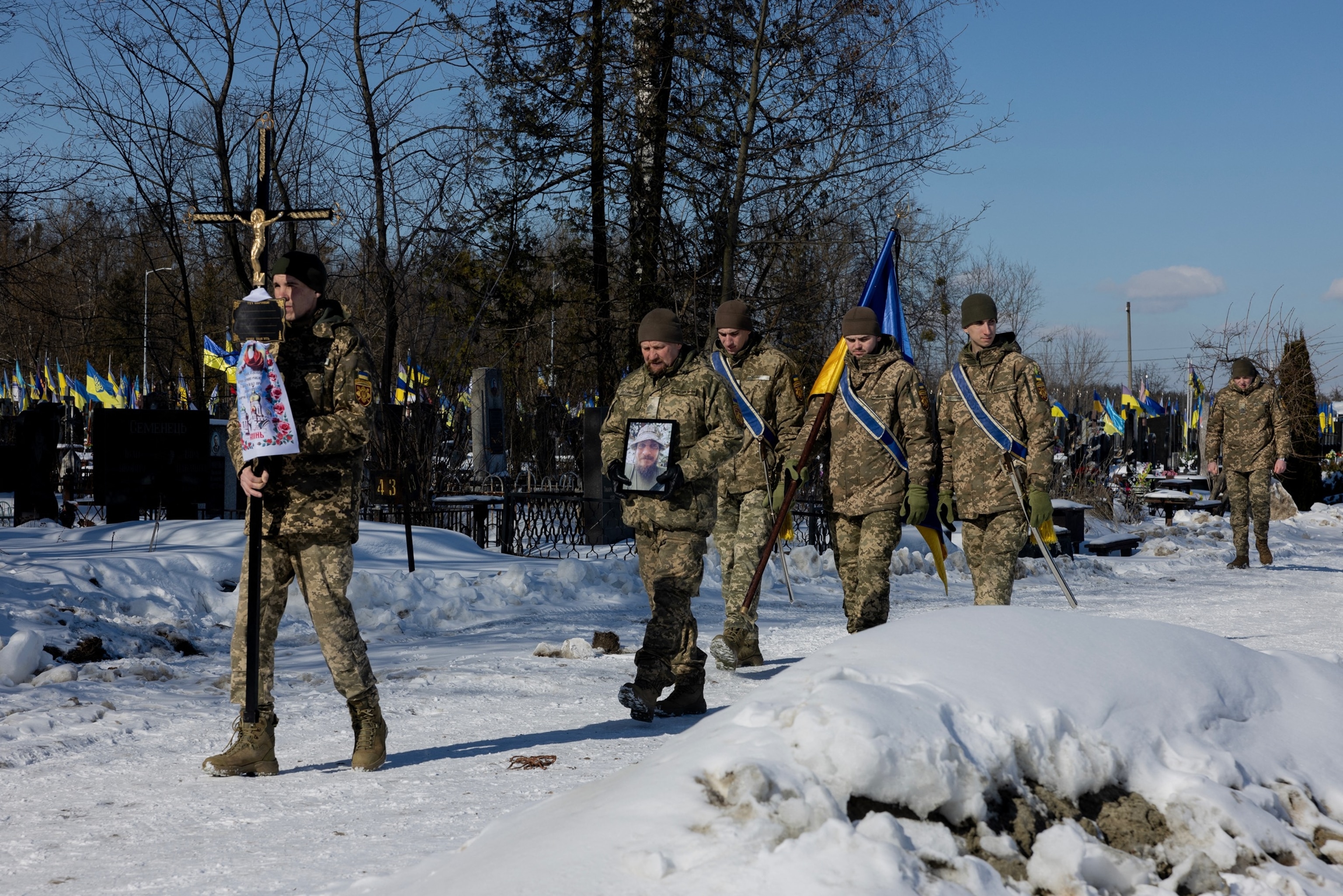 PHOTO: Ukrainian soldiers carry the portrait of Oleksandr Krasikov, callsign "Sambo," a Ukrainian serviceman and ultras member of Football Club Dynamo Kyiv, who was killed in the battle during a funeral ceremony in Kyiv on Feb. 20, 2026.