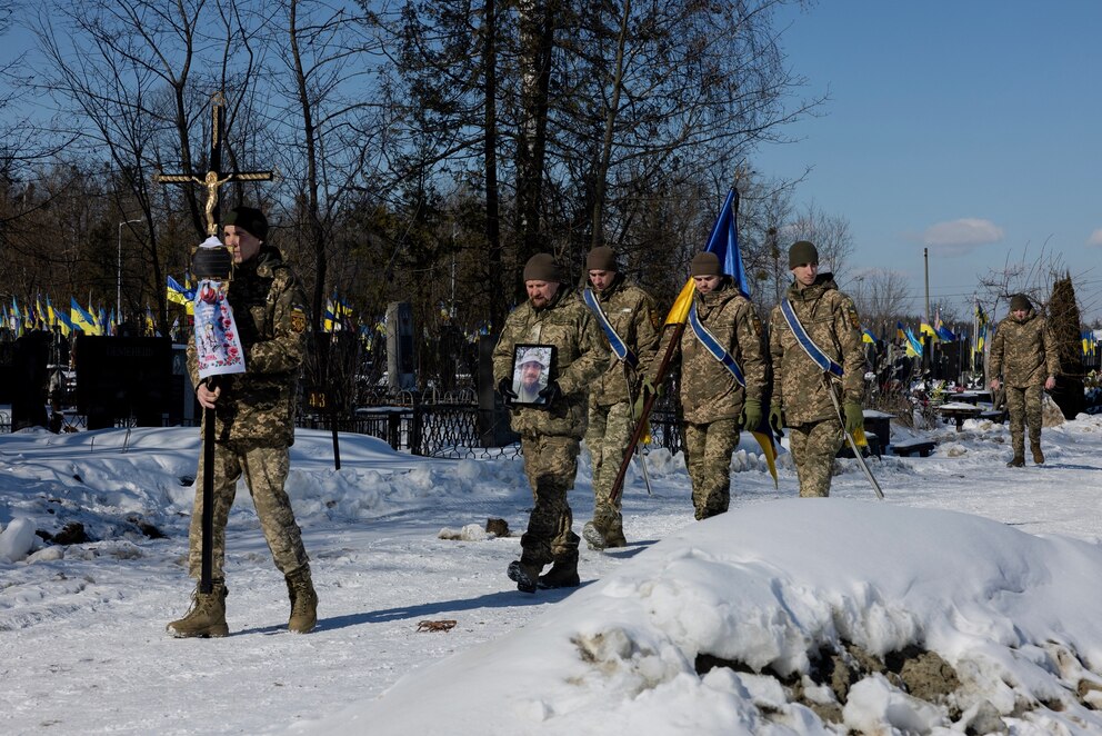 PHOTO: Ukrainian soldiers carry the portrait of Oleksandr Krasikov, callsign "Sambo," a Ukrainian serviceman and ultras member of Football Club Dynamo Kyiv, who was killed in the battle during a funeral ceremony in Kyiv on Feb. 20, 2026.