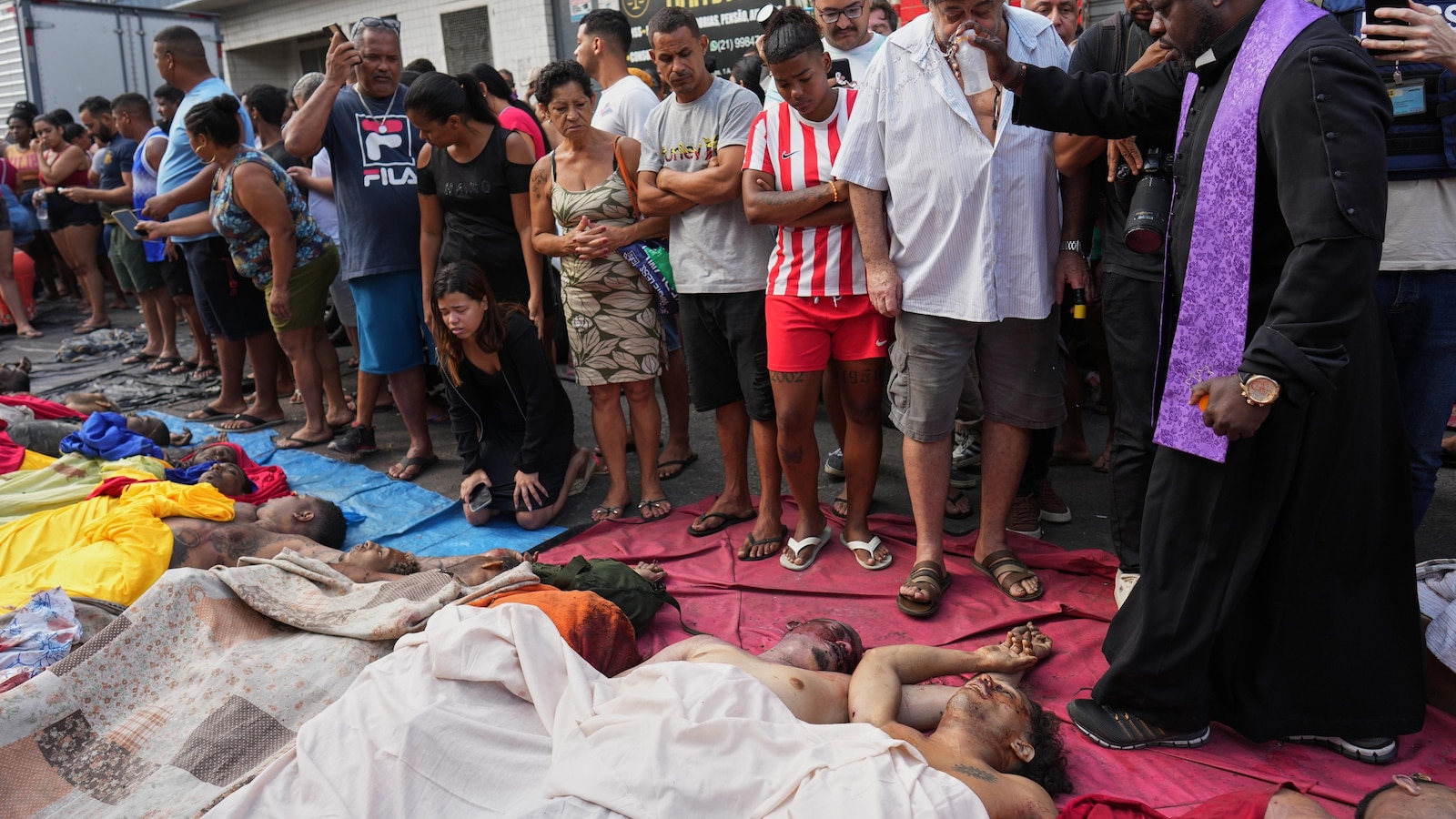 Brazilians in a Rio favela line up bodies after the city's deadliest police raid