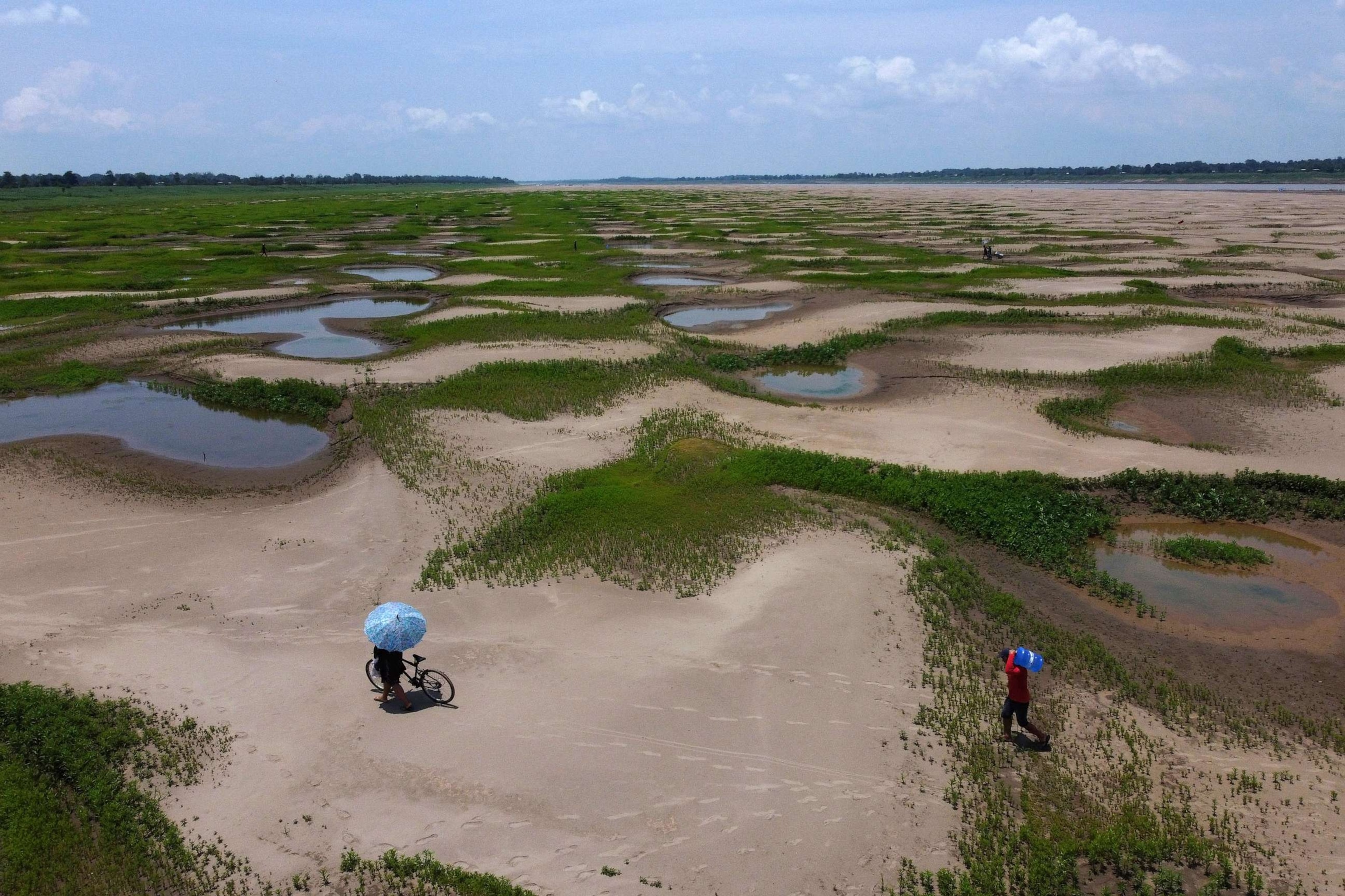 PHOTO: Residents of a riverside community carry food and containers of drinking water after receiving aid due to the ongoing drought in Careiro da Varzea, Amazonas state, Brazil, Oct. 24, 2023.