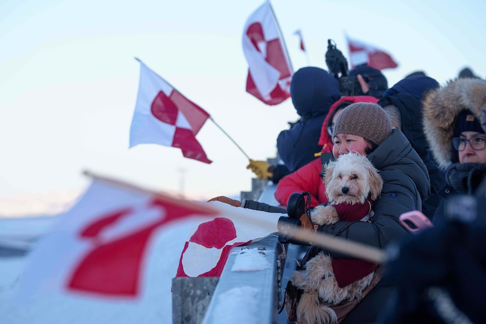 PHOTO: People wave national flags for Greenland Minister for Foreign Affairs and Research Vivian Motzfeldt as she arrives at the airport in Nuuk, Greenland,  Jan. 20, 2026. 