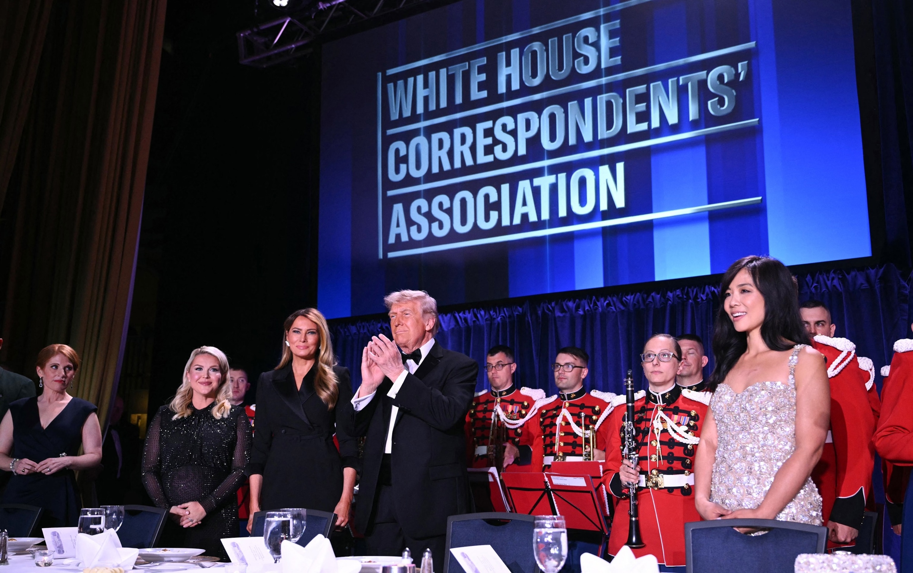 PHOTO: In this April 25, 2026, file photo, Karen Travers,  Karoline Leavitt, First Lady Melania Trump, President Donald Trump and CBS News correspondent Weijia Jiang attend the White House Correspondents' dinner in Washington, D.C.