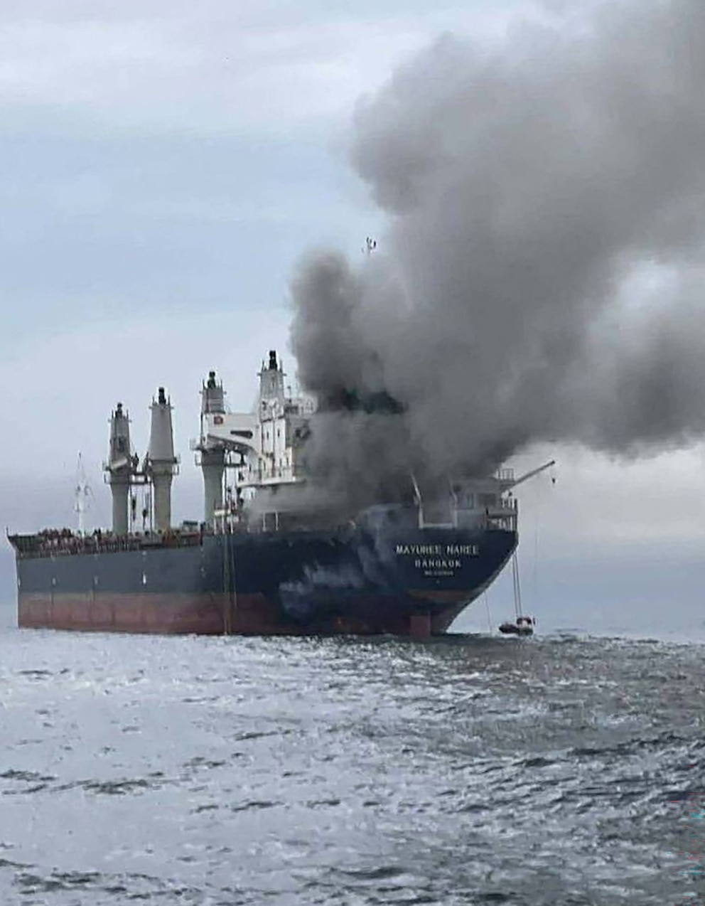 PHOTO: This handout photo taken on March 11, 2026, and released by the Royal Thai Navy shows smoke rising from the Thai bulk carrier "Mayuree Naree" near the Strait of Hormuz after an attack.