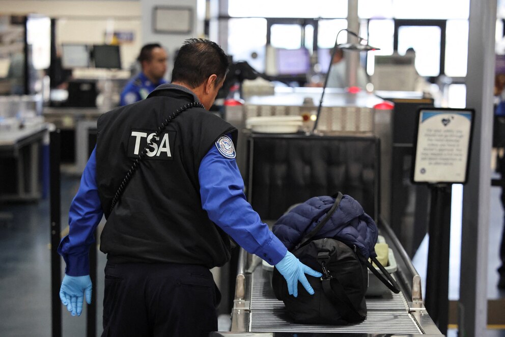 PHOTO: Transportation Security Administration (TSA) works during the first day of a partial U.S. government shutdown in Burbank