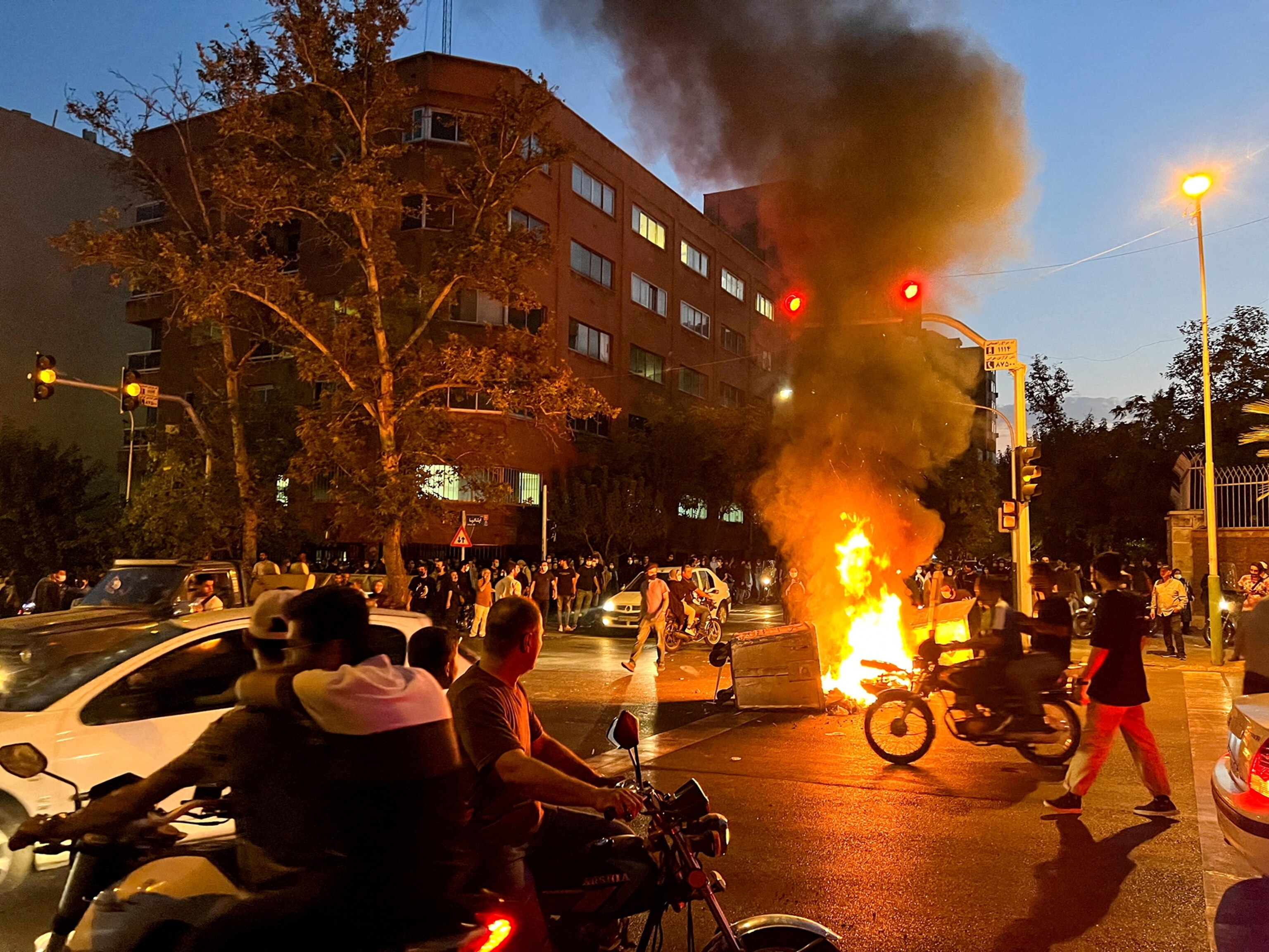 PHOTO: A police motorcycle burns during a protest over the death of Mahsa Amini, a woman who died after being arrested by the Islamic republic's "morality police", in Tehran, Iran, Sept. 19, 2022.