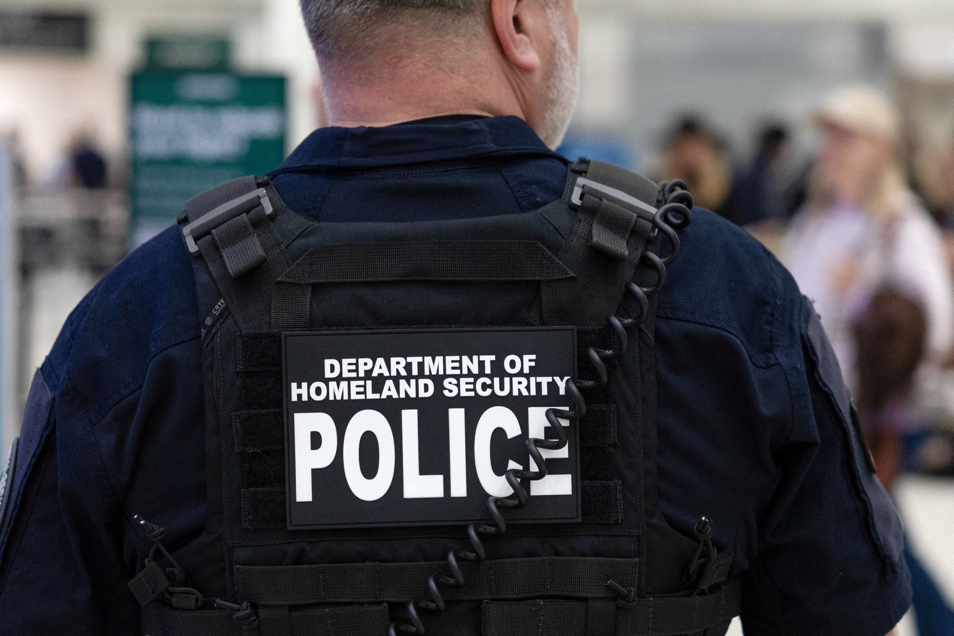PHOTO: A Department of Homeland Security officer directs passengers as they wait in long TSA lines at the George Bush Intercontinental Airport in Houston, Texas, March 25, 2026.    