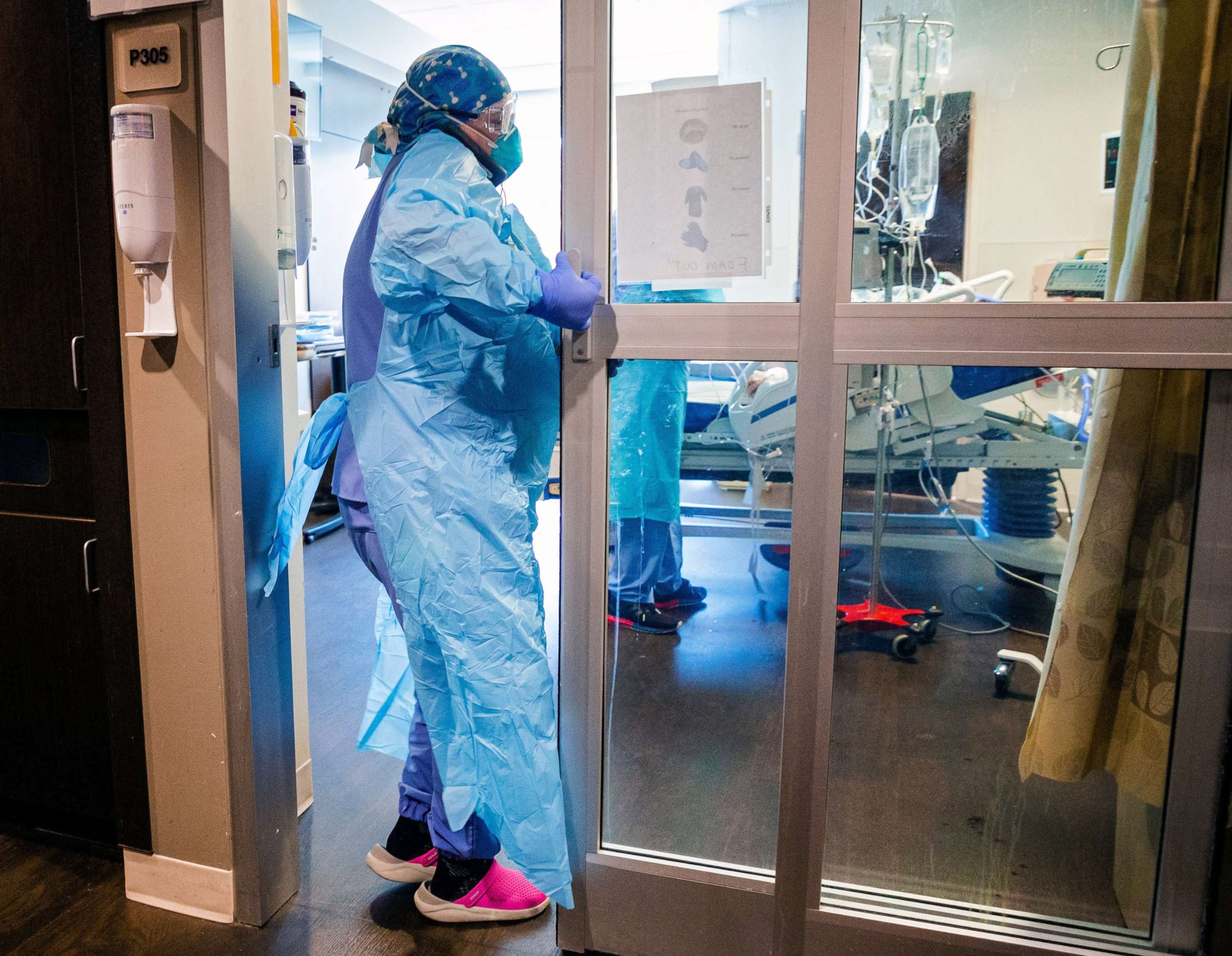 PHOTO: A nurse enters a room Tuesday in the COVID ICU to administer treatment to a patient at SSM Health St. Anthony Hospital.

CP choice 2