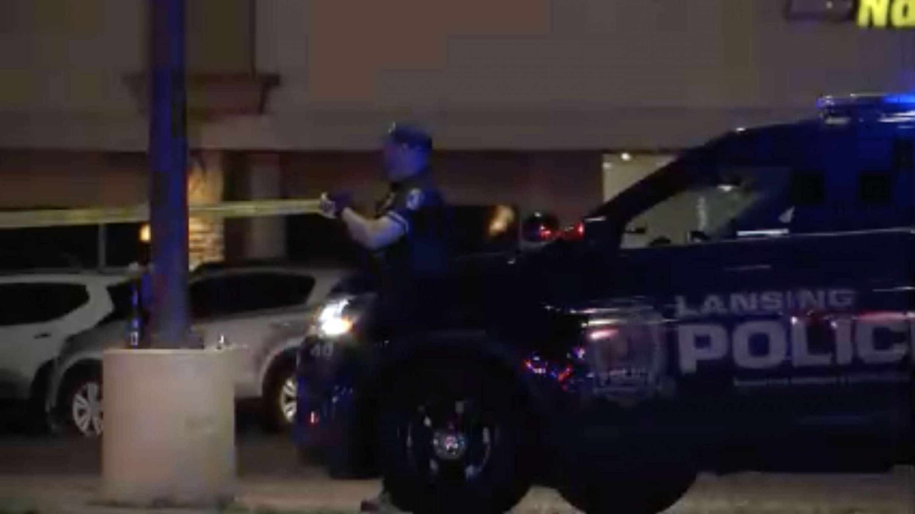 PHOTO: Police officers cordon off a crime scene at the Logan Square Mall in Lansing on July 30, 2023, after a shooting left five people injured, two in critical condition.