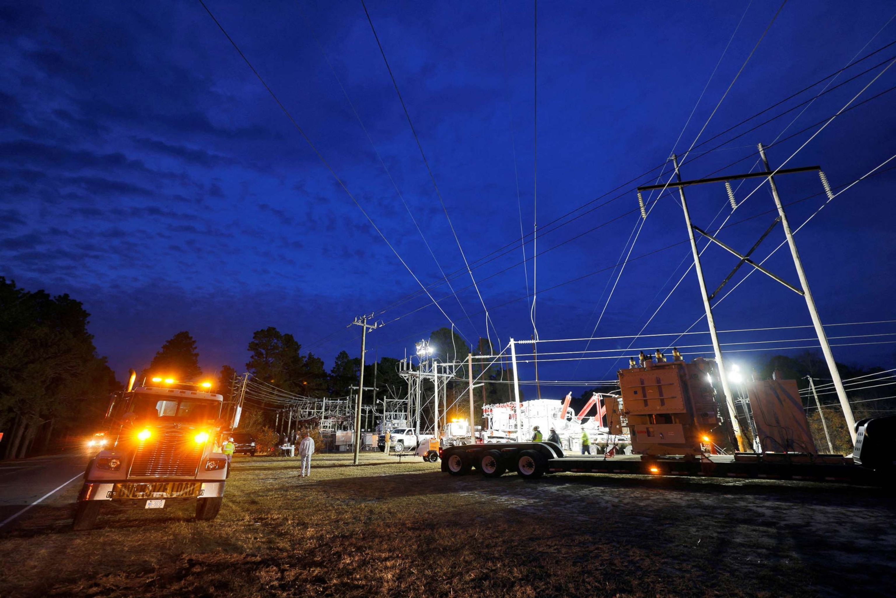 PHOTO: Duke Energy personnel work to restore power at a crippled electrical substation that the workers said was hit by gunfire after the Moore County Sheriff said that vandalism caused a mass power outage, in Carthage, North Carolina, Dec. 4, 2022.