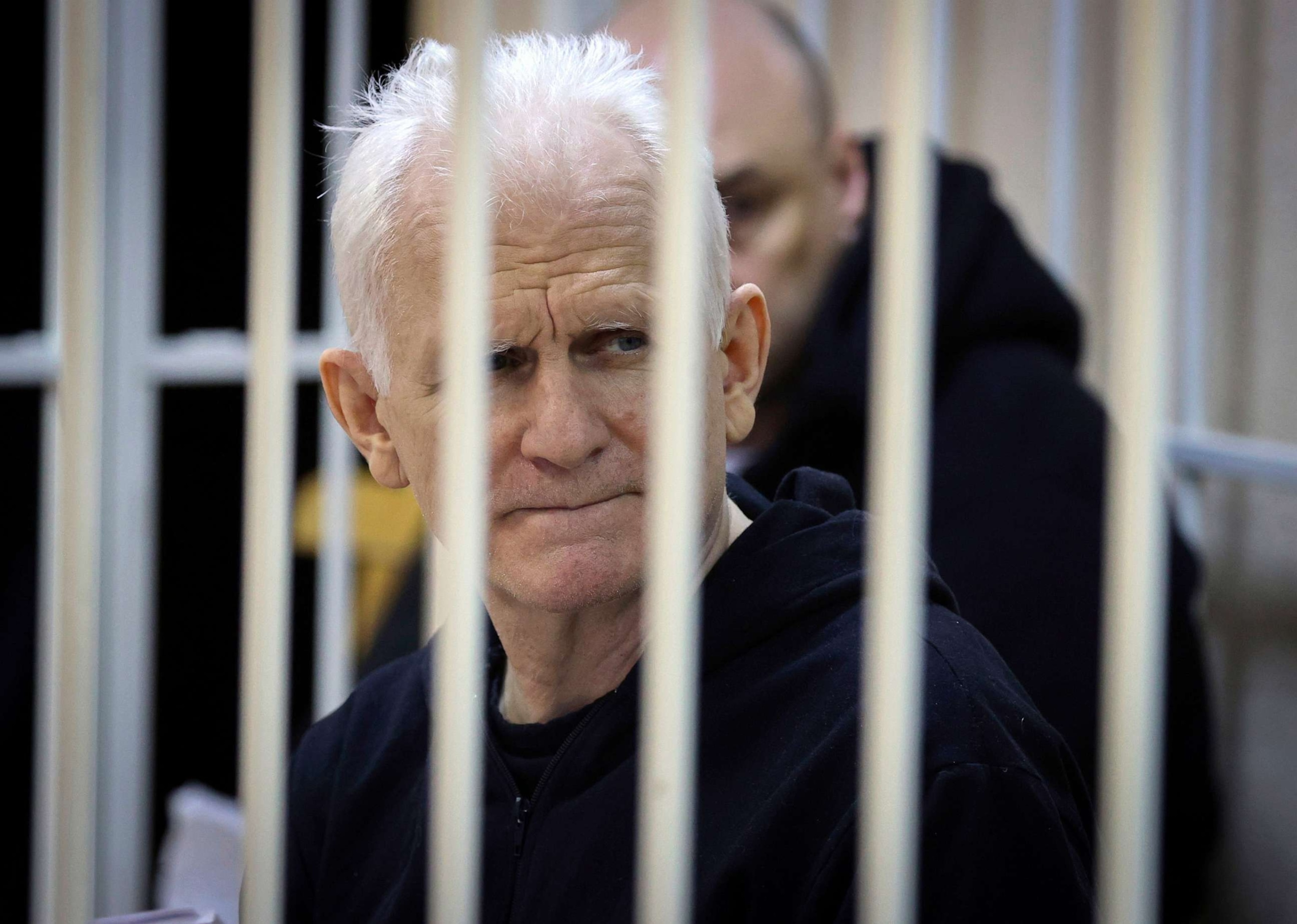 PHOTO: Ales Bialiatski, the head of Belarusian Vyasna rights group, sits in a defendants' cage during a court session in Minsk, Belarus, Jan. 5, 2023.