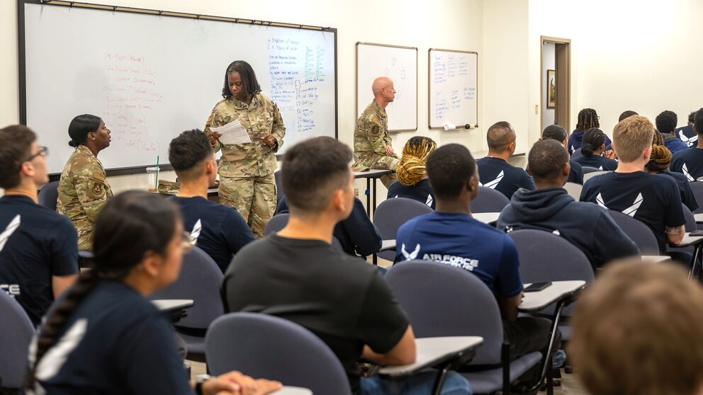 PHOTO: U.S. Air Force Reserve Master Sgt. Denise Alston, recruiting flight chief for the 315th Airlift Wing, works with her team to prepare future Airmen for departure to basic military training at Joint Base San Antonio-Lackland, Texas. 