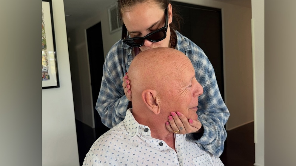 Bruce Willis is sharing a sweet father-daughter moment with Tallulah Willis. Tallulah Willis shared a rare new photo with her father on Instagram on Monday, showing her kissing the actor on the forehead while gently holding his head.