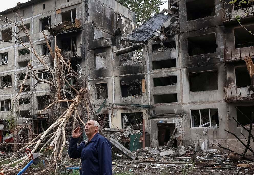 PHOTO: A resident stands near buildings damaged by Russian military strikes in the frontline town of Myrnohrad
