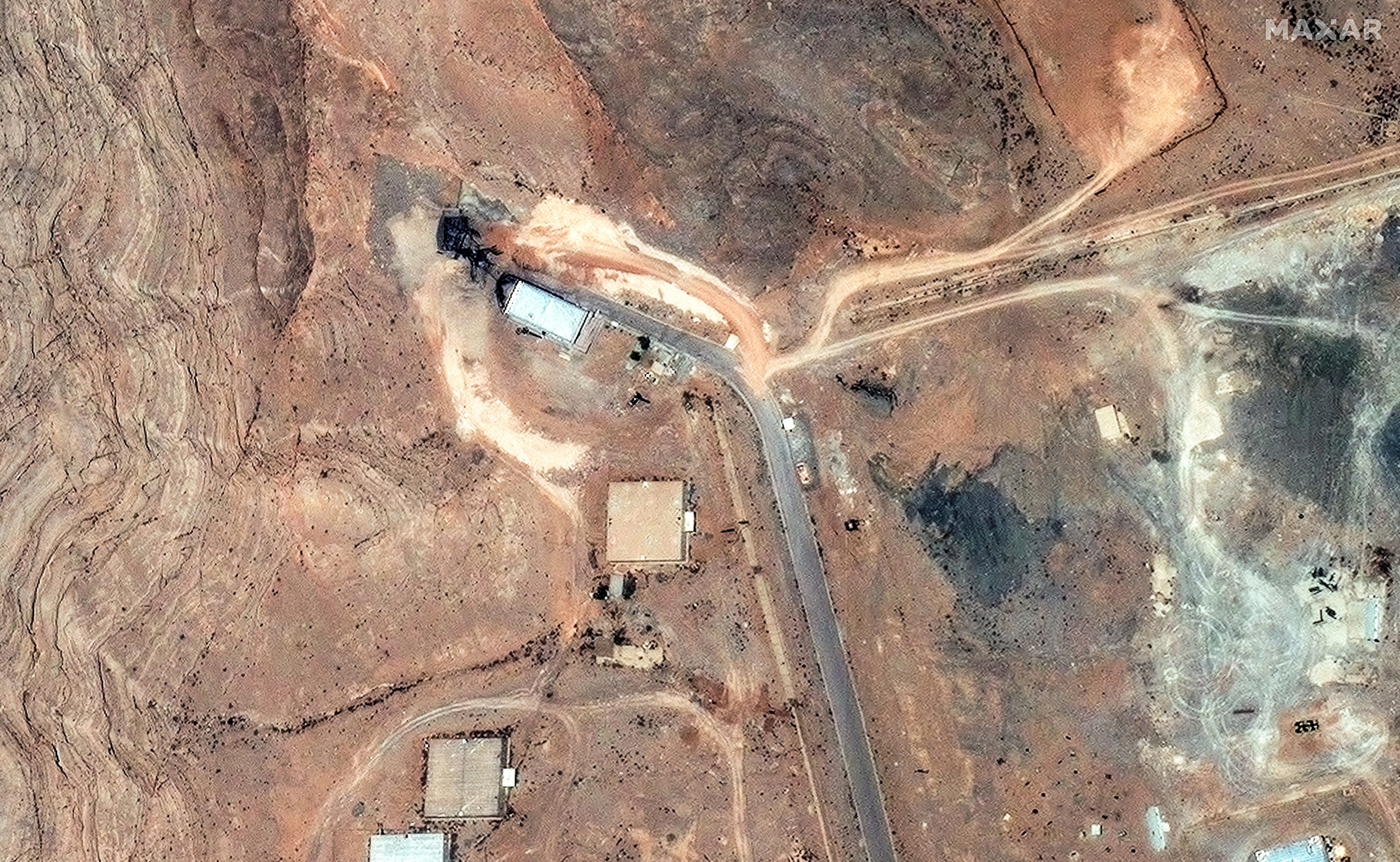 PHOTO: A satellite image shows airstrike damage to the tunnel entrances of the Isfahan Nuclear Technology Research Center