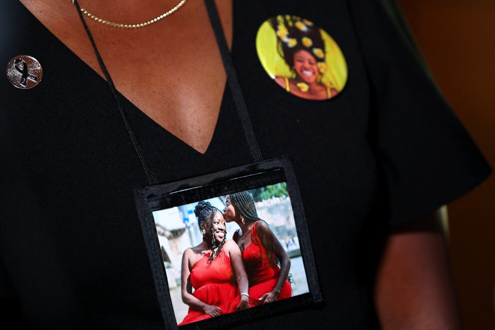 PHOTO: A victim's relative wears an image on her neck during a National Transportation Safety Board (NTSB) investigative hearing at NTSB headquarters in Washington, D.C., July 30, 2025.
