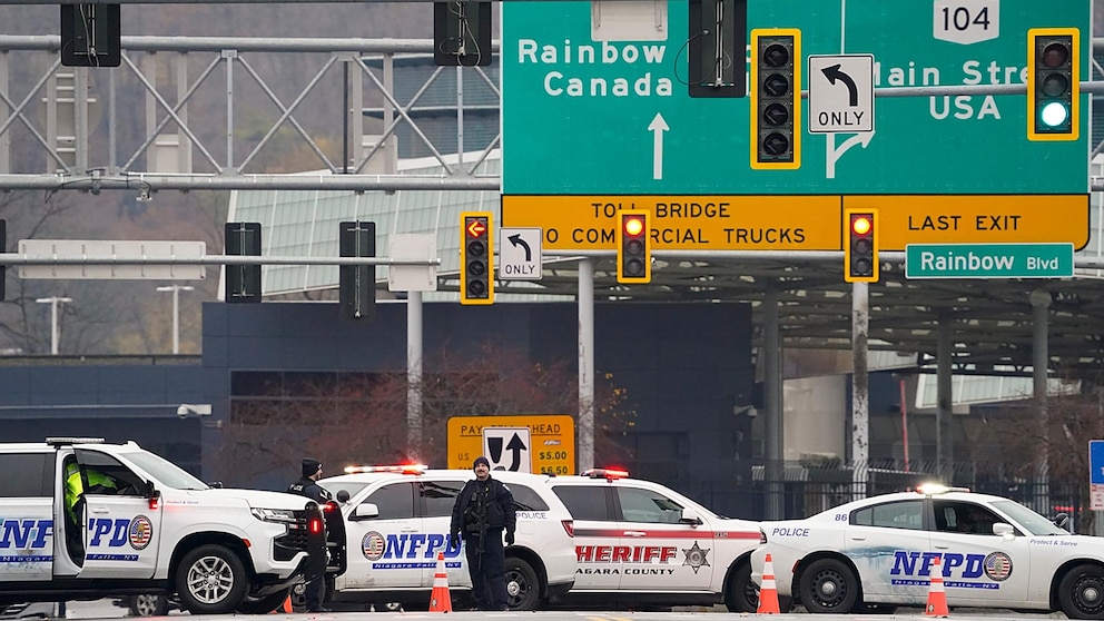 Law enforcement personnel block off the entrance to the Rainbow Bridge, Wednesday, Nov. 22, 2023, in Niagara Falls, N.Y. The border crossing between the U.S. and Canada has been closed after a vehicle exploded at a checkpoint on a bridge near Niagara Falls. The FBI's field office in Buffalo said in a statement that it was investigating the explosion on the Rainbow Bridge, which connects the two countries across the Niagara River. (Derek Gee/The Buffalo News via AP)