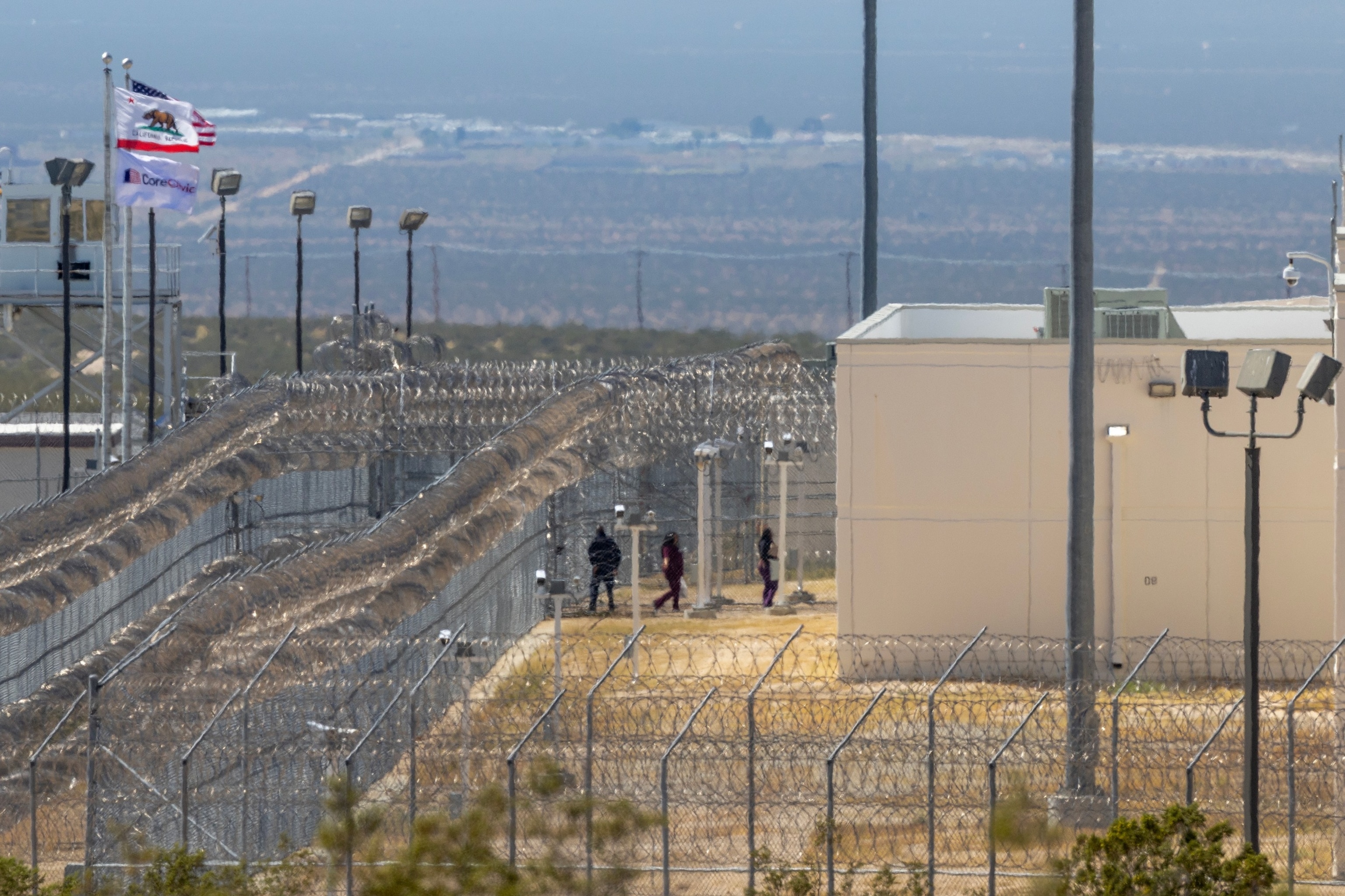 PHOTO: People enter the California City Immigration Processing Center, the state's newest and largest ICE prison, on March 25, 2026, in California City, Calif. 