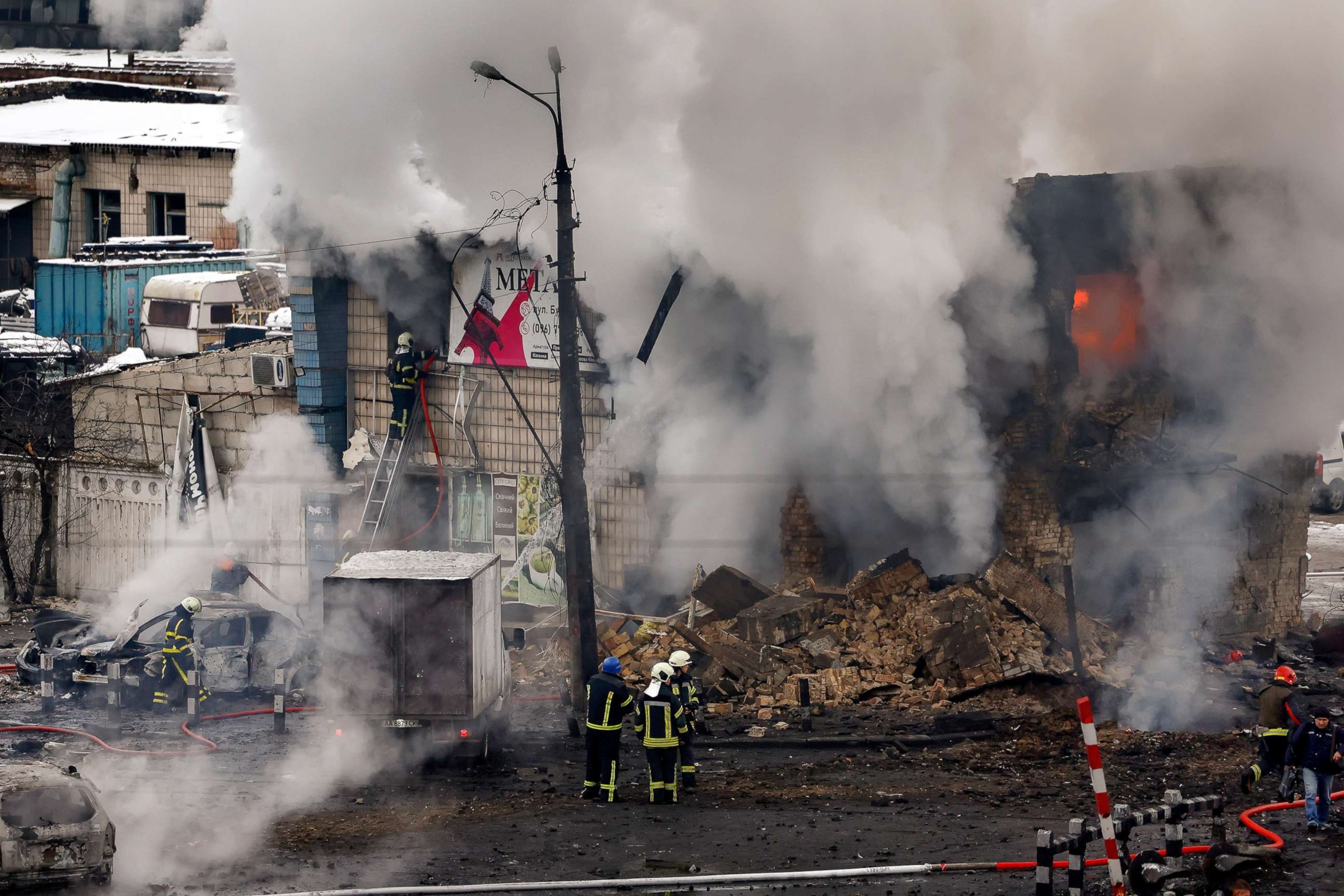 PHOTO: Fire and rescue workers attend a building hit by a missile in central Kyiv, on Nov. 23, 2022, in Kyiv, Ukraine.