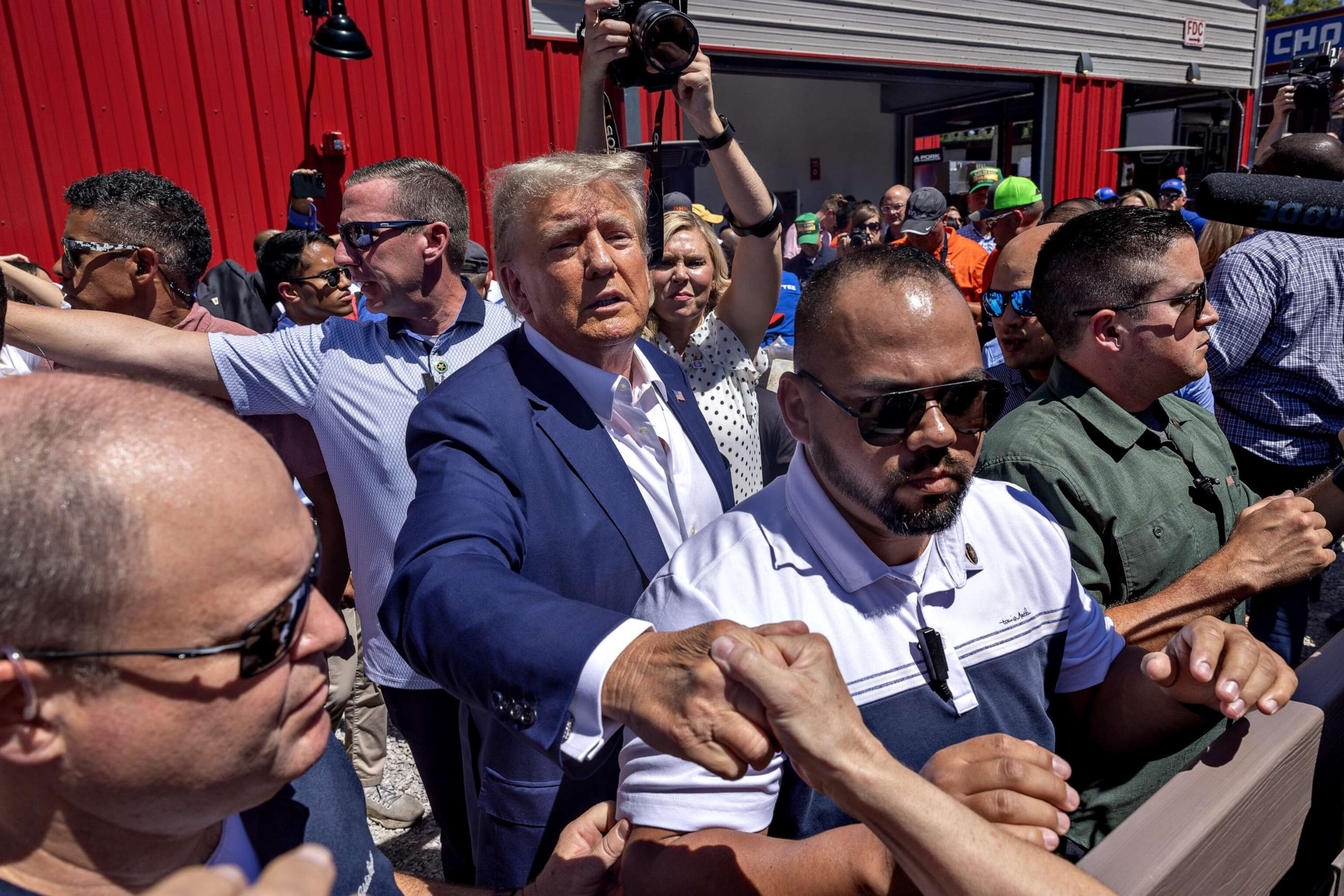 PHOTO: Former President Donald Trump, 2024 Republican presidential candidate greets attendees while touring the Iowa State Fair in Des Moines, Iowa, Aug. 12, 2023.