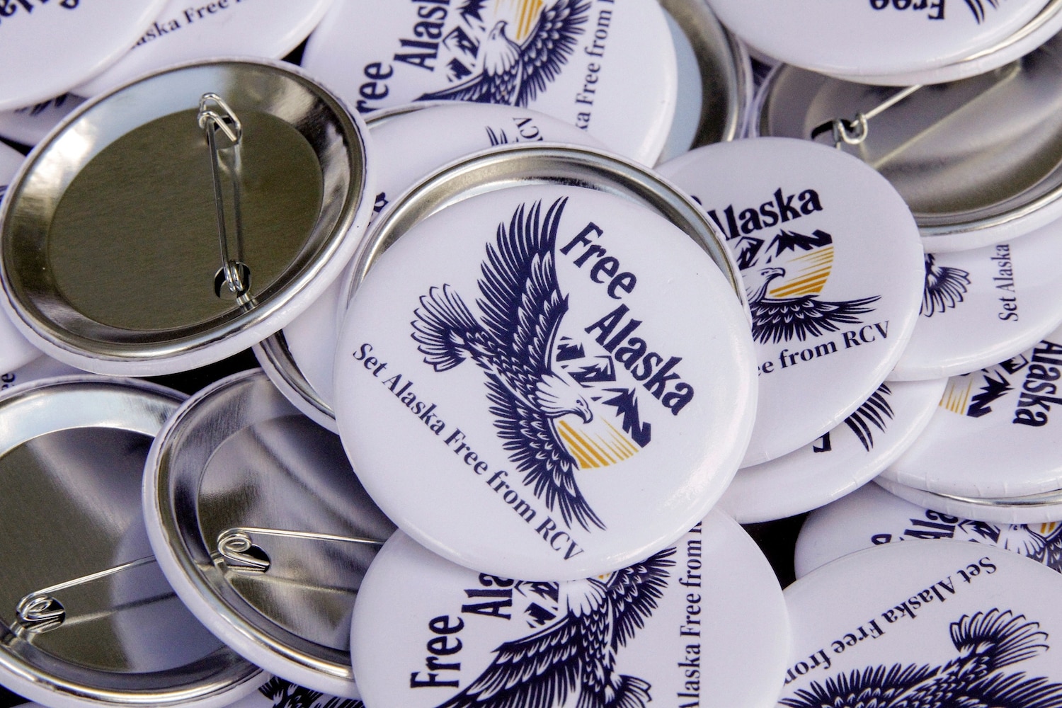 Campaign buttons urging Alaskans to repeal ranked choice voting in Alaska sit on a picnic table at the home of Phil Izon, a backer of the initiative, in Wasilla, Alaska, May 14, 2024. Mark Thiessen/AP
