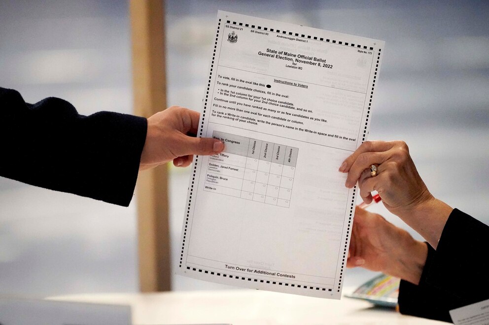 PHOTO: A clerk hands a ballot to a voter on Election Day, Nov. 8, 2022, in Lewiston, Main