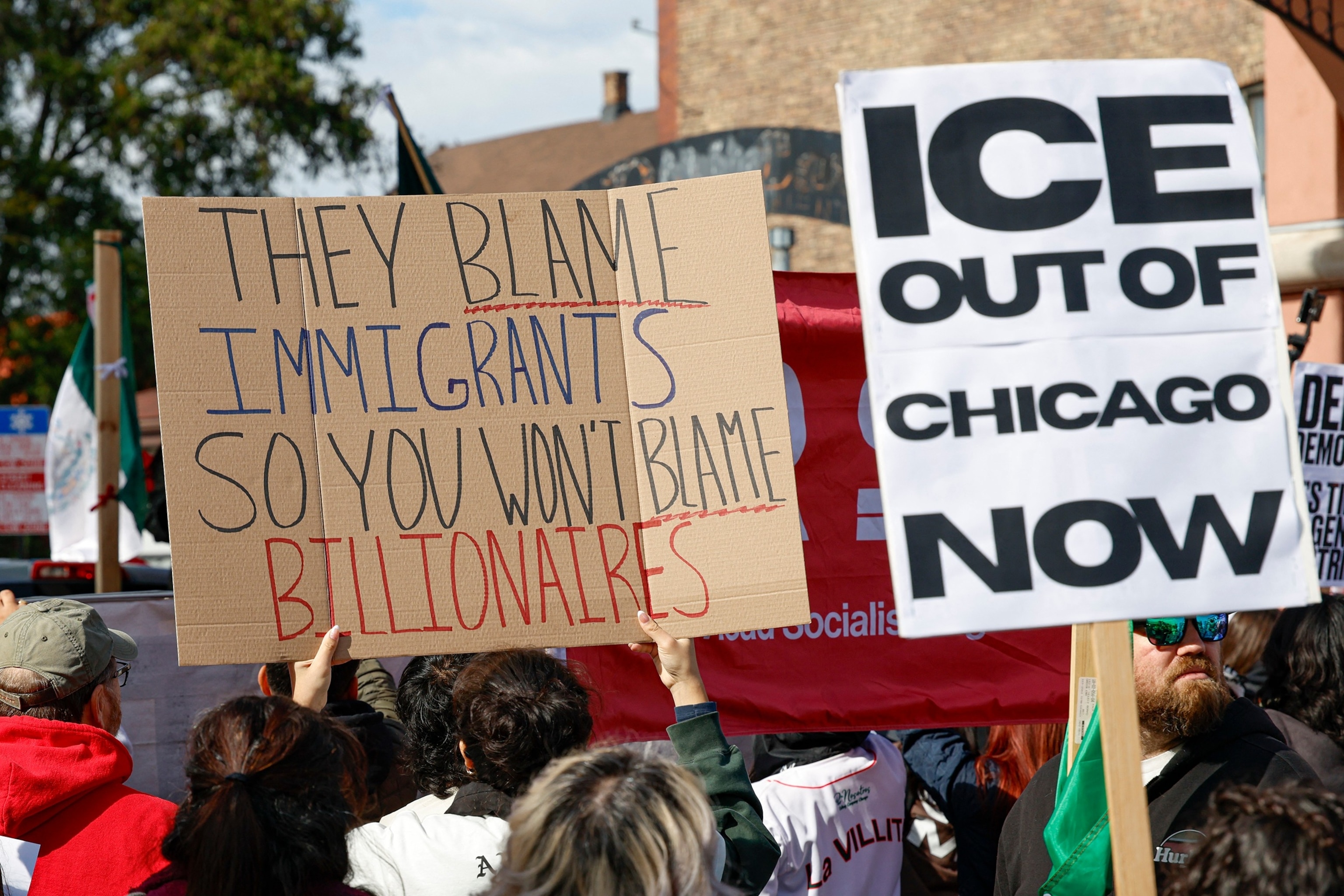 PHOTO: Protesters hold signs against Immigration and Customs Enforcement during a demonstration at the predominantly Mexican-American neighborhood of Little Village, also known as "La Villita", in Chicago, Oct. 25, 2025.