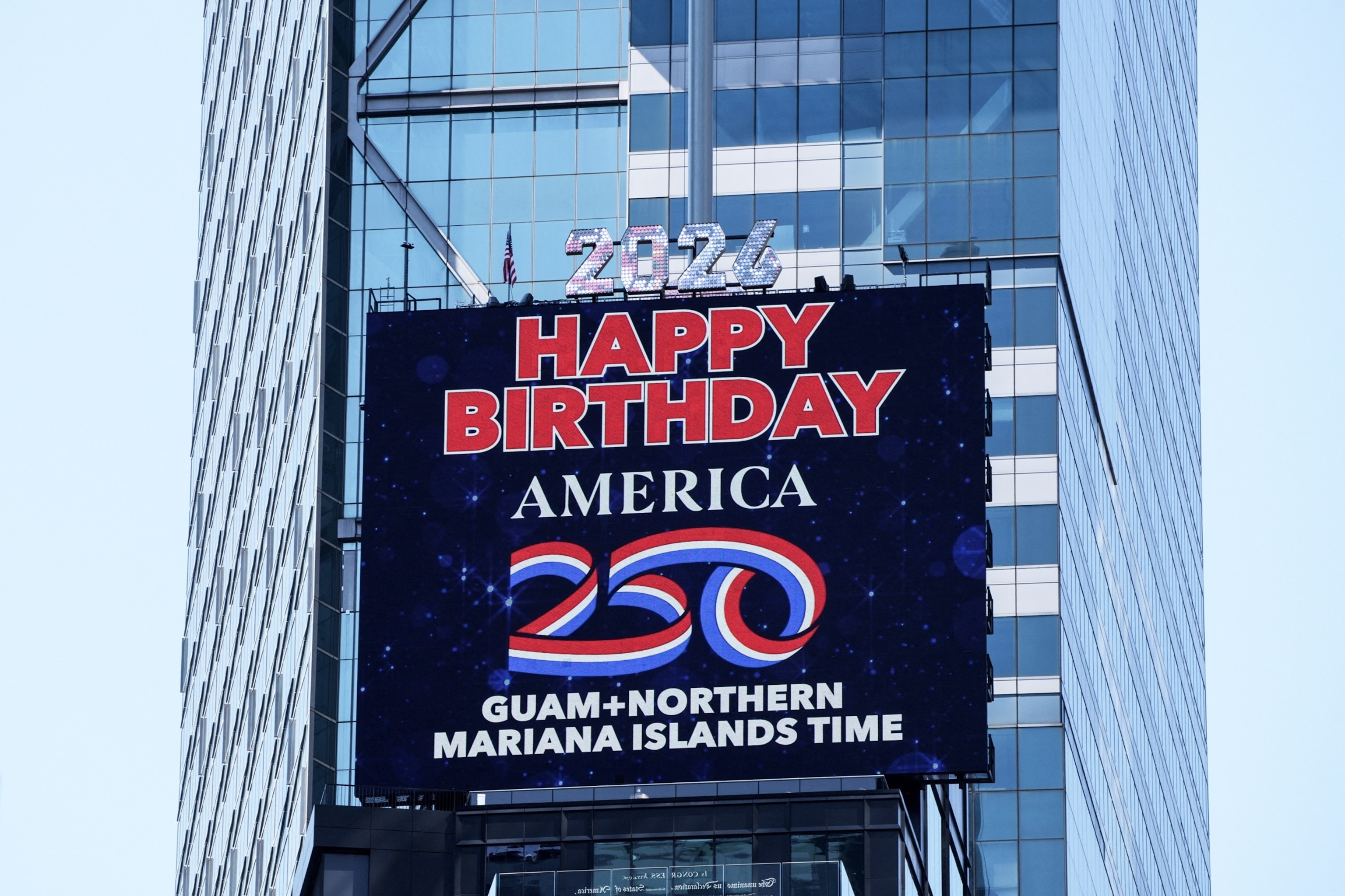 PHOTO: A screen displays "Happy Birthday America 250" after a ball drop marking the stroke of midnight in Guam and the Northern Mariana Islands, in New York, July 3, 2026. 