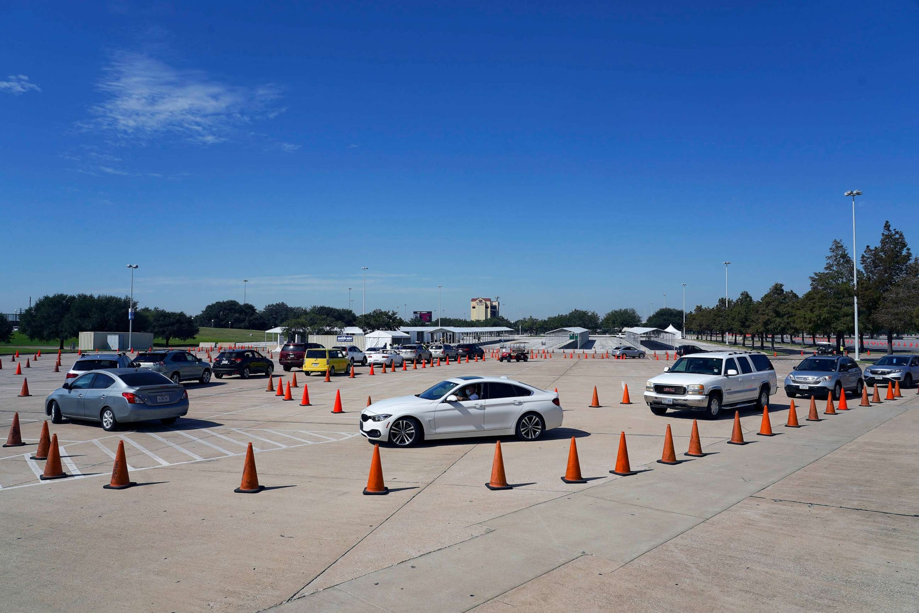 PHOTO: FILE - Voters in cars line up at a drive-through mail ballot drop-off site at NRG Stadium, Oct. 7, 2020 in Houston.