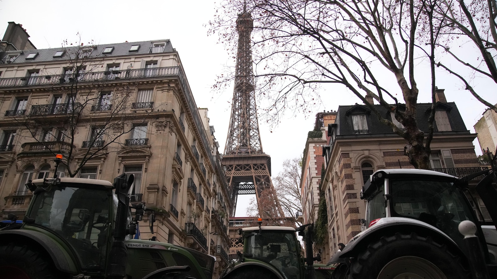 French farmers force their way through Paris with tractors to protest free trade deal
