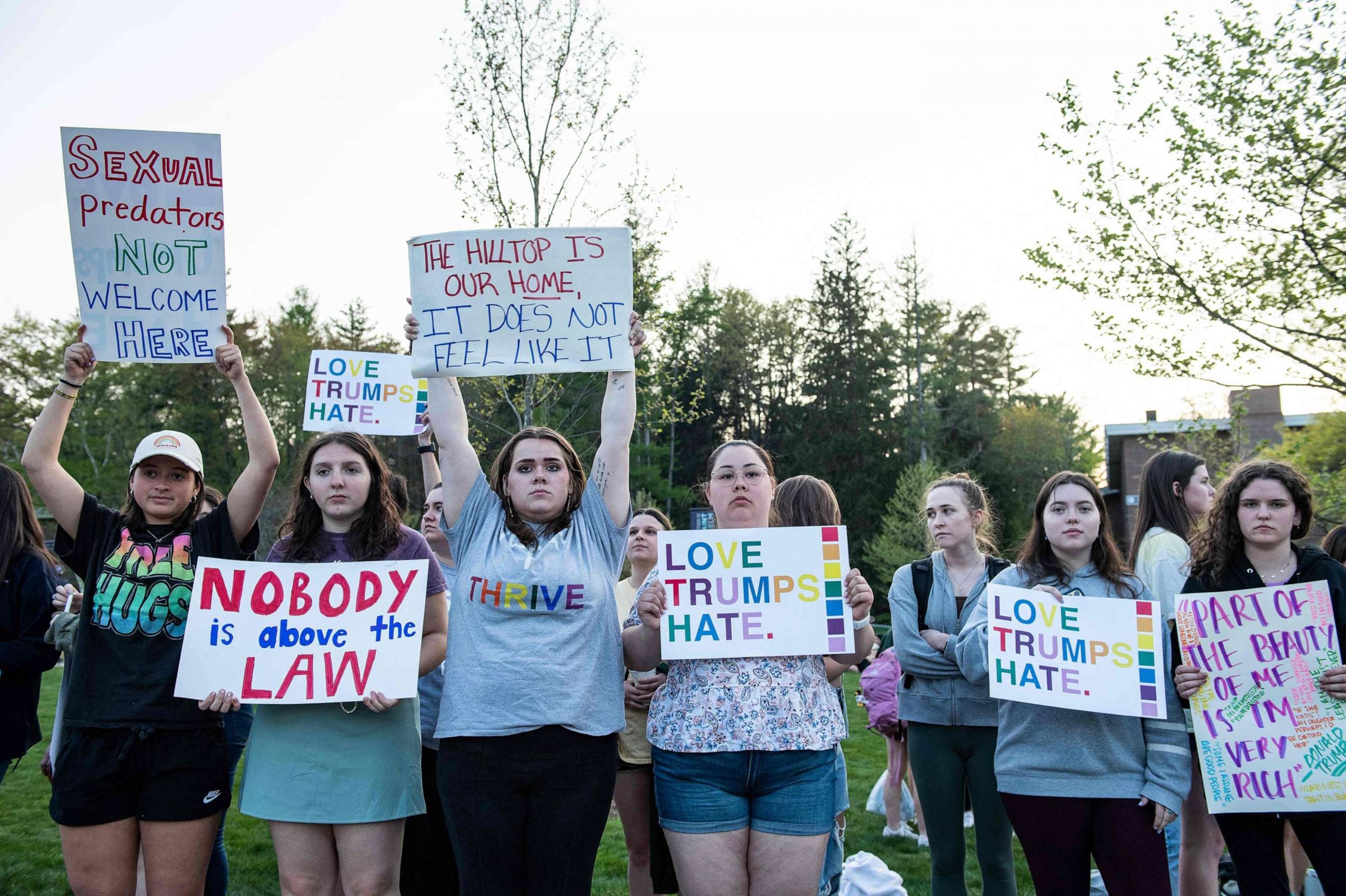 PHOTO: Demonstrators at St. Anselm College protest against former President and 2024 Presidential hopeful Donald Trump in Manchester, New Hampshire, on May 10, 2023, ahead of his CNN town hall meeting.