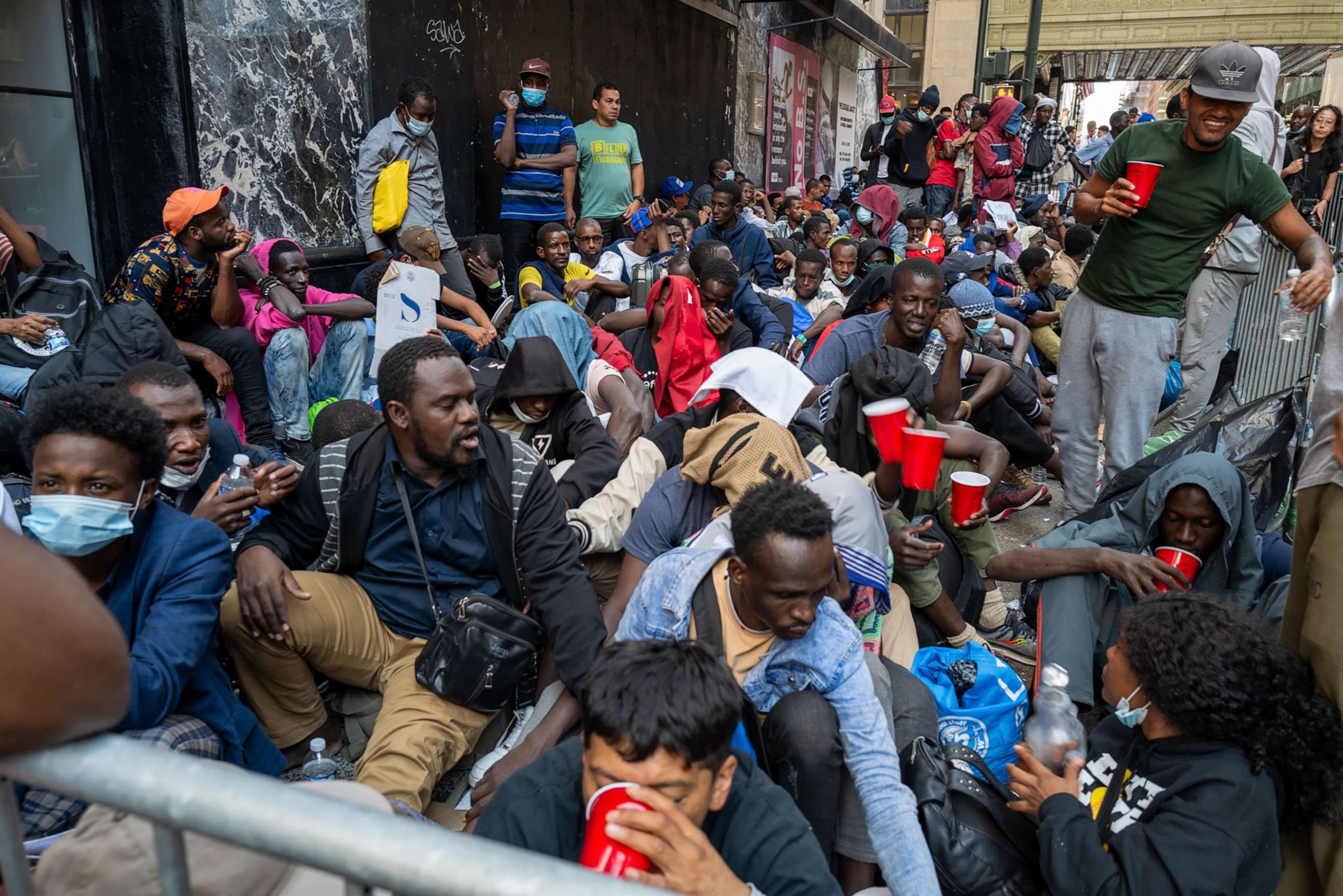 PHOTO: Dozens of recently arrived migrants to New York City camp outside of the Roosevelt Hotel, which has been made into a reception center, as they try to secure temporary housing on Aug. 1, 2023 in New York City.