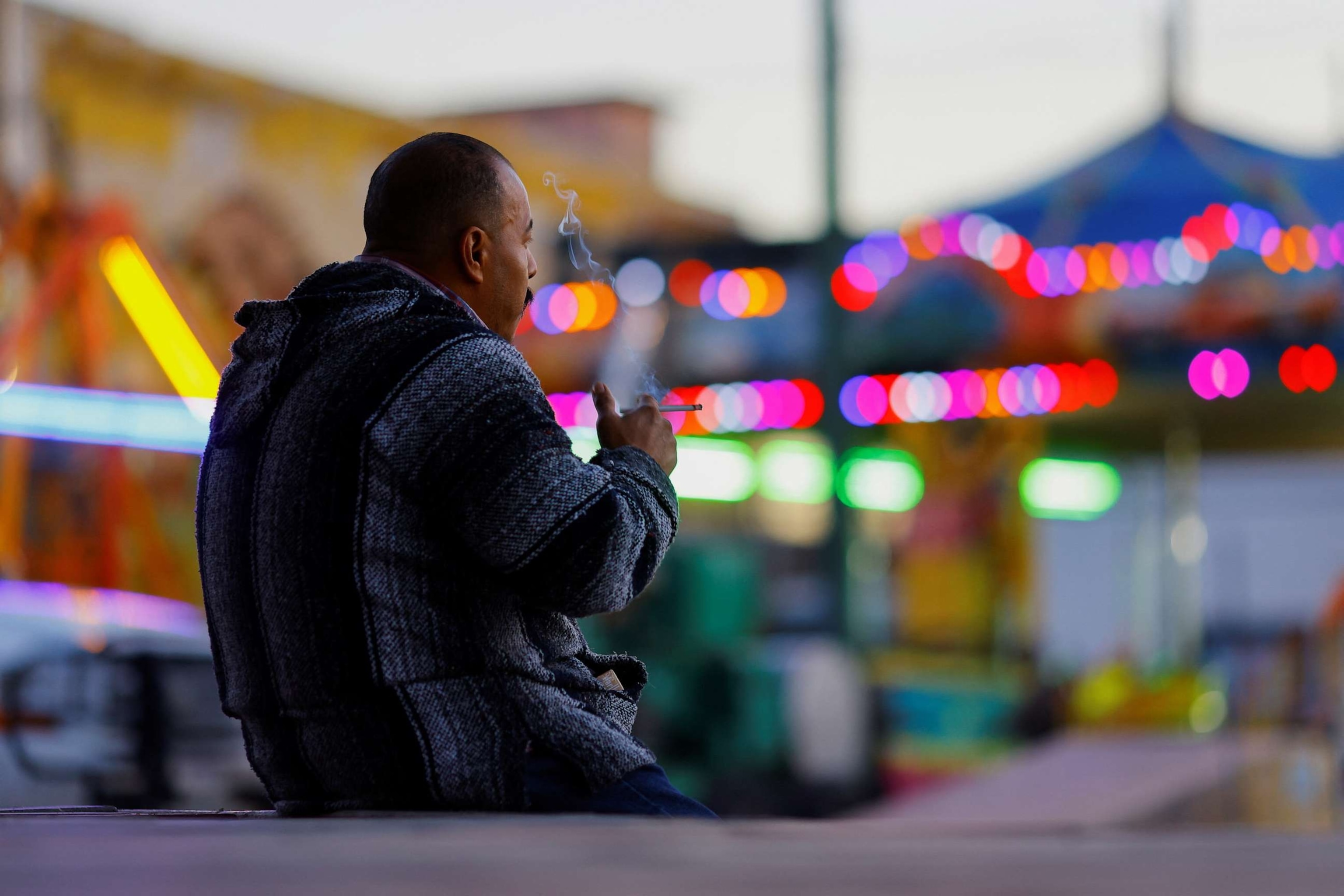 PHOTO: A man smokes in a public plaza, before smoking in public spaces is prohibited according to a reform by the Mexican Government to the country's Regulation of the General Law for Tobacco Control, in downtown Ciudad Juarez, Mexico Jan. 13, 2023.