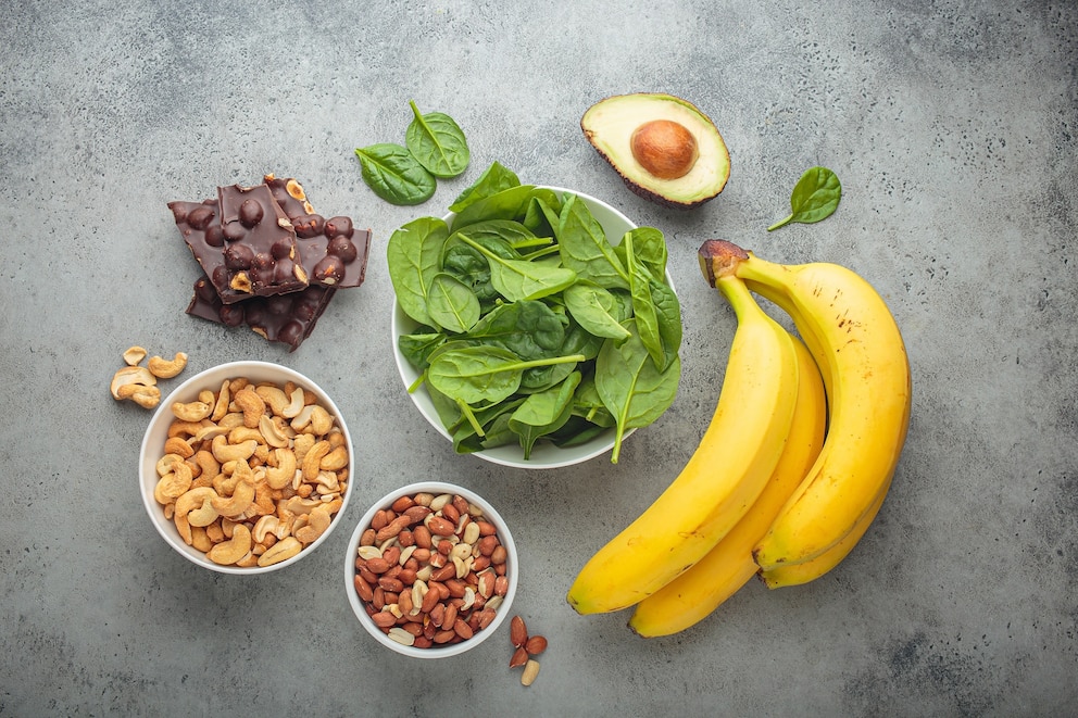 PHOTO: Magnesium rich foods including bananas, spinach, peanuts, cashews, and dark chocolate top view