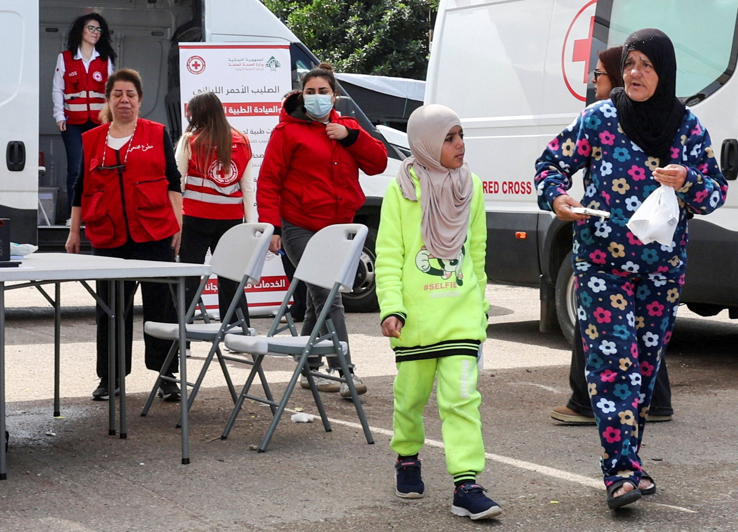 PHOTO: A displaced woman walk with her daughter after receiving medical treatment from the Lebanese Red Cross at a medical aid point assisting displaced civilians following an escalation between Hezbollah and Israel in Beirut, Lebanon, March 16, 2026.