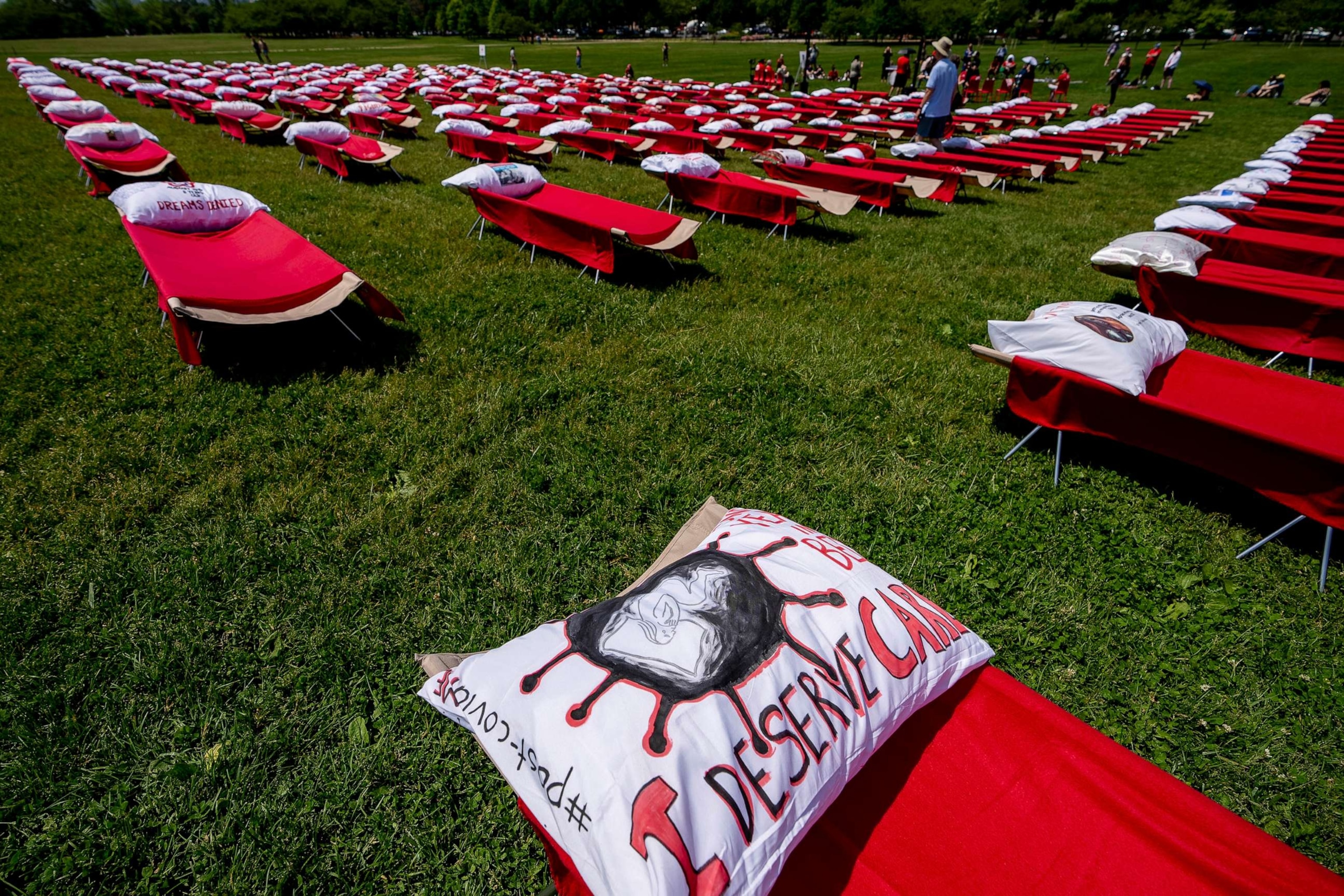 PHOTO: A pillow is decorated with the words "I Deserve Care" as advocates for people suffering from long COVID-19 and myalgic encephalomyelitis/chronic fatigue syndrome host an installation of 300 cots in Washington, D.C., May 12, 2023