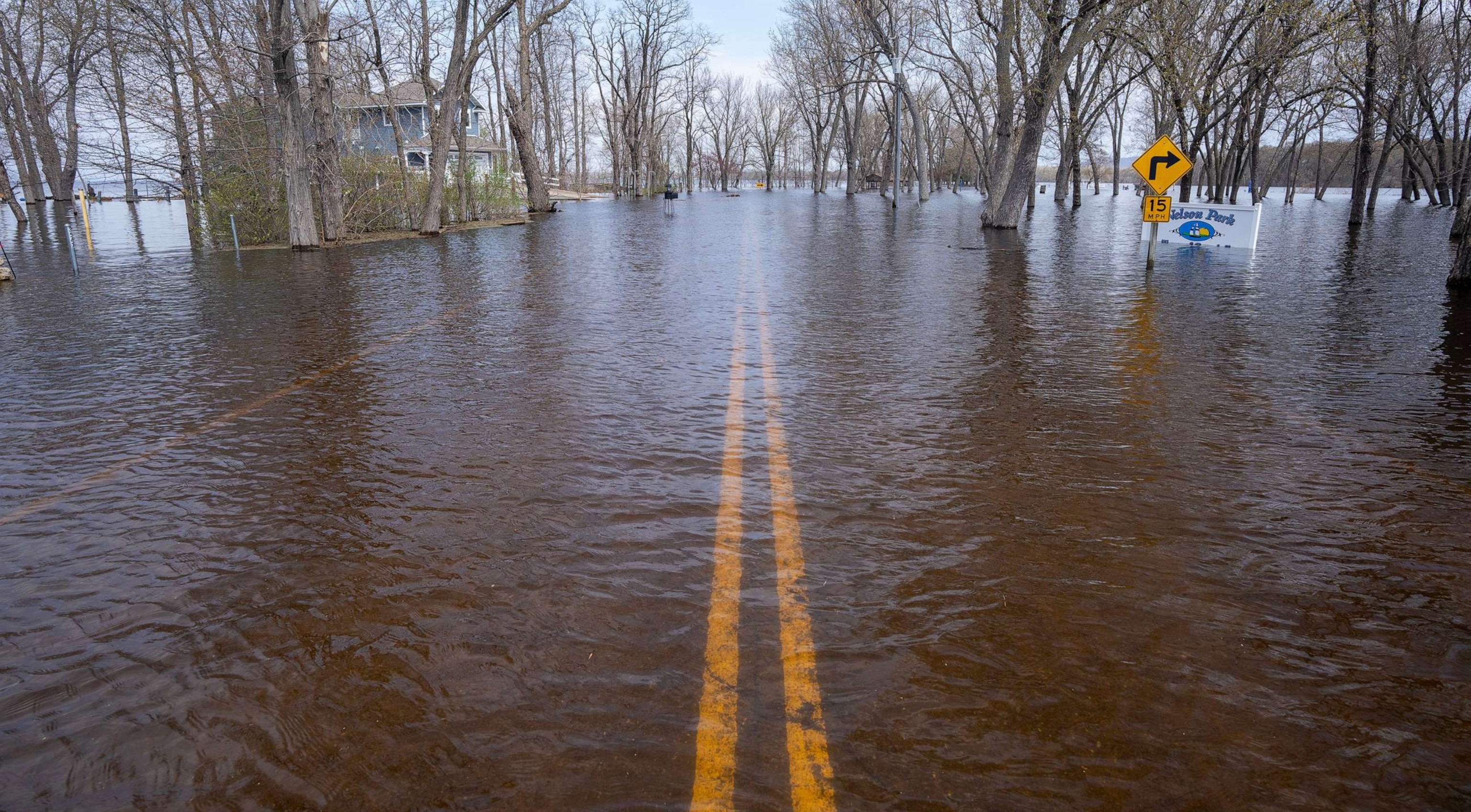 PHOTO: A road along the Mississippi River covered by floodwaters, April 27, 2023, in the Town of Campbell just outside La Crosse, Wis.